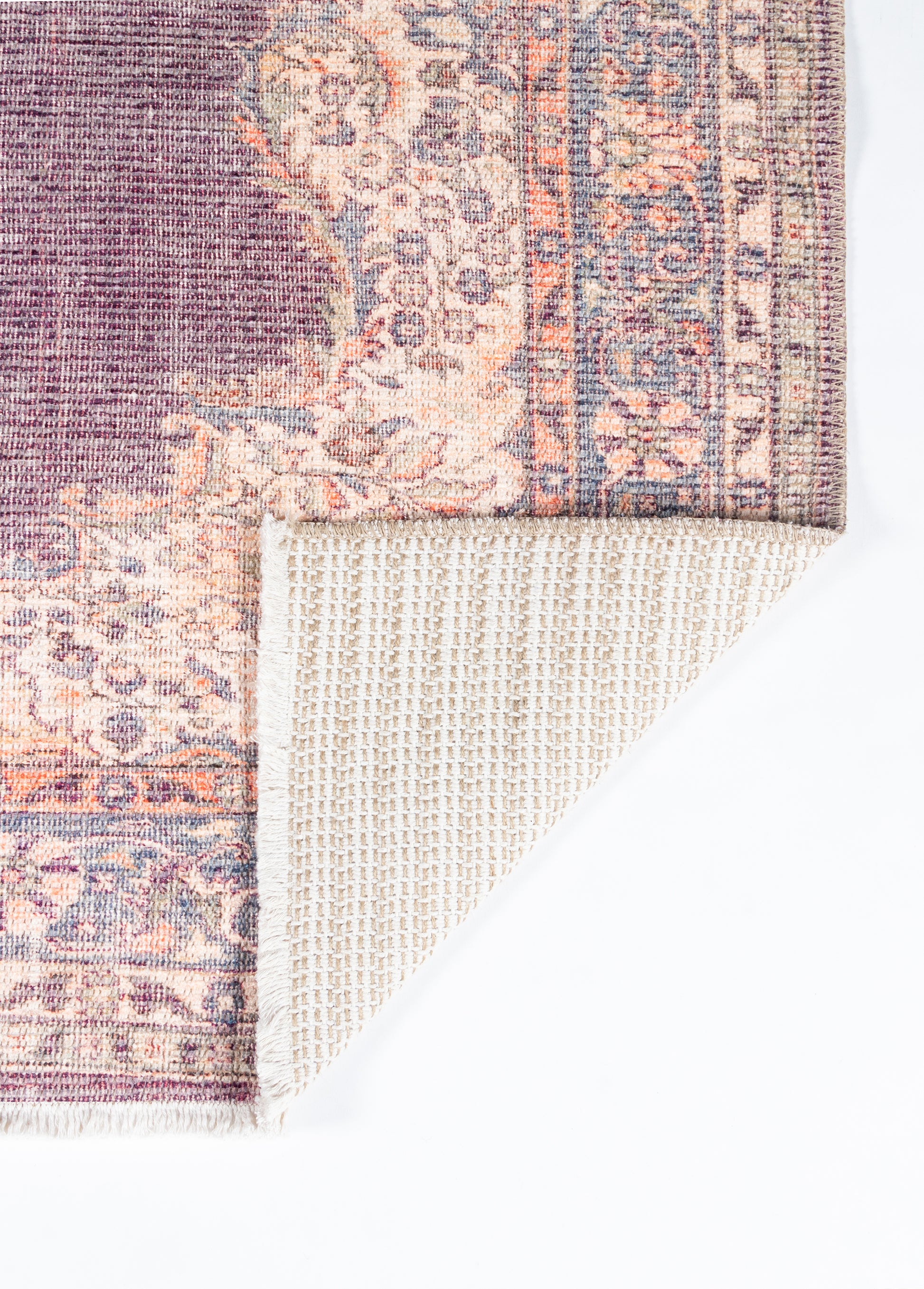 Purple & pink oriental runner rug with floral motif and decorative border; beige woven backing shown at corner.