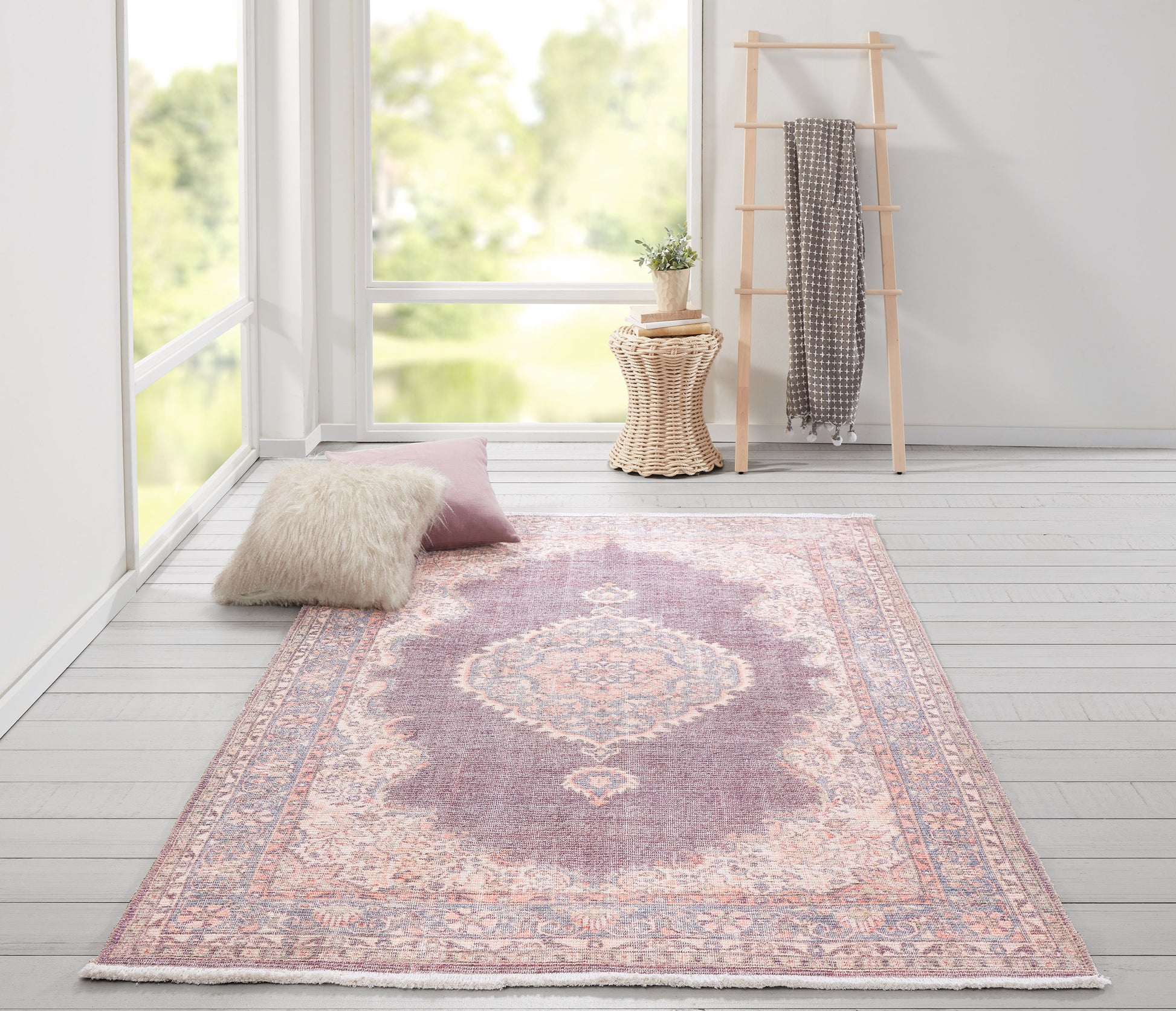 Lavender-pink oriental rug with ivory medallion, ornate border and fringed edges for a soft decorative living space accent.