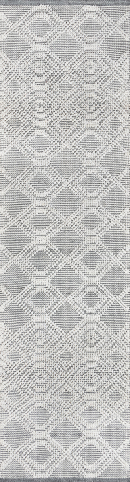 Neutral gray rug with cream raised diamond lattice pattern and small dot accents; textured woven surface.