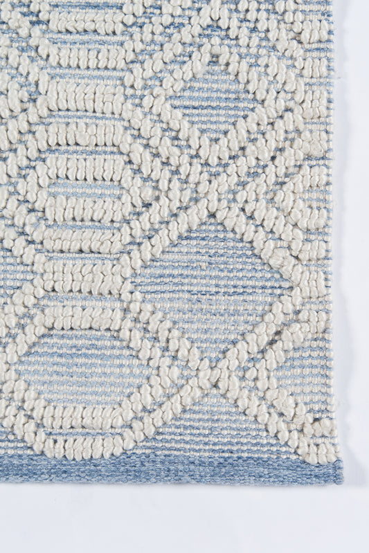 Ivory and light blue textured woven rug with raised loop geometric lattice pattern and blue border.