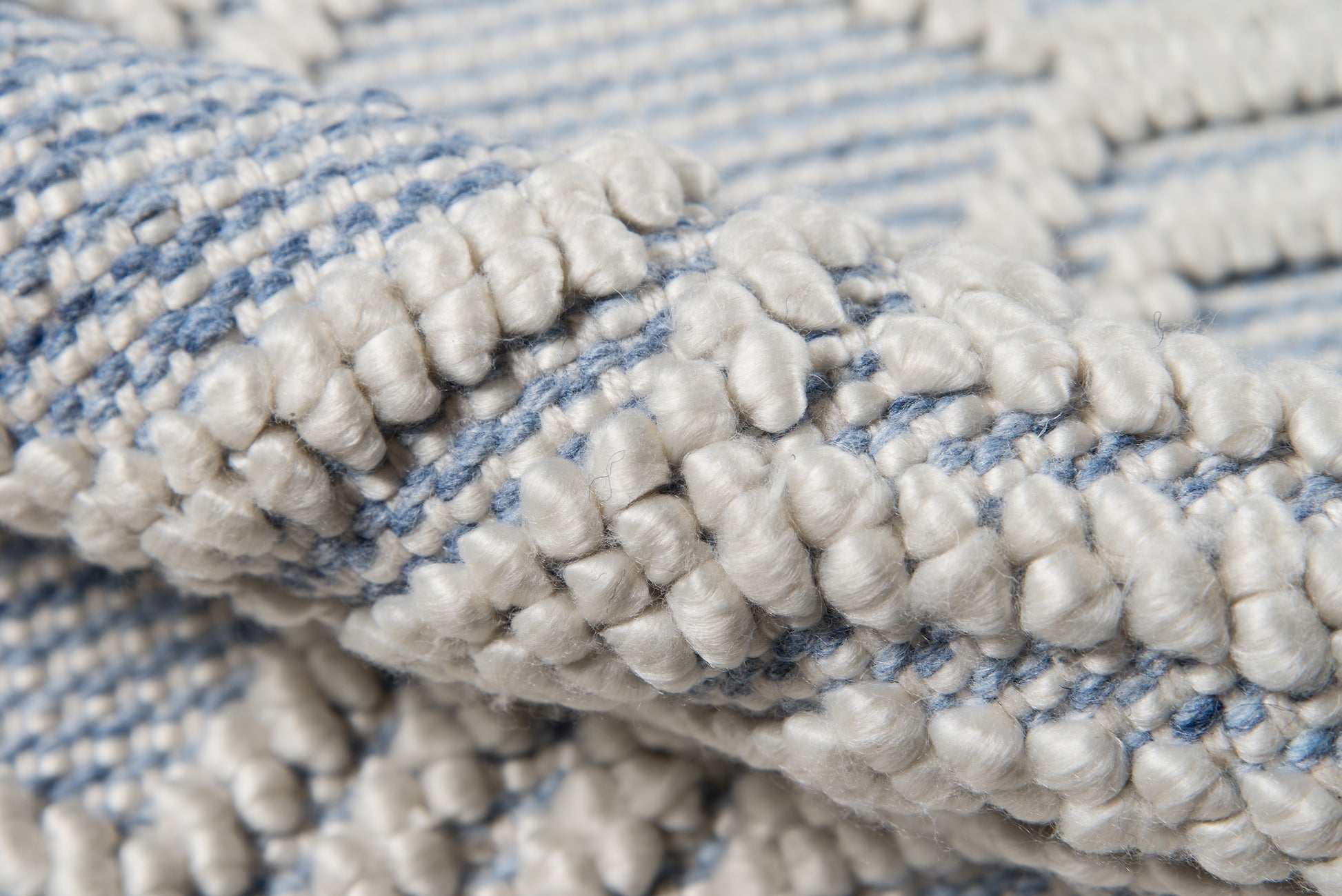 Blue and white boucle runner rug with chunky loop pile texture.