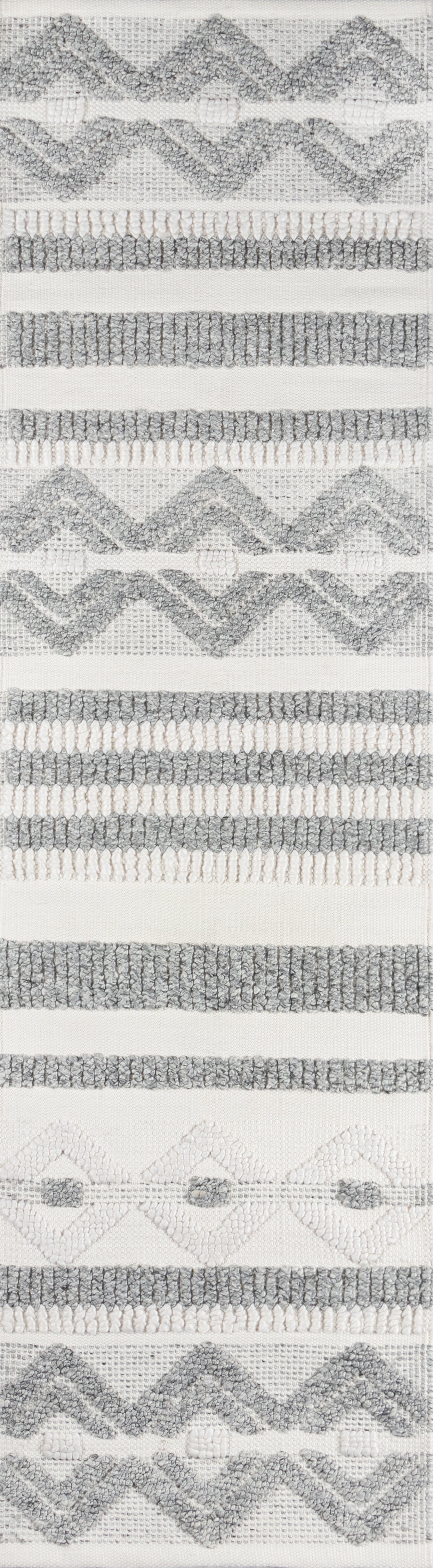 Ivory woven rug with gray boucle zigzag chevrons and horizontal striped bands.