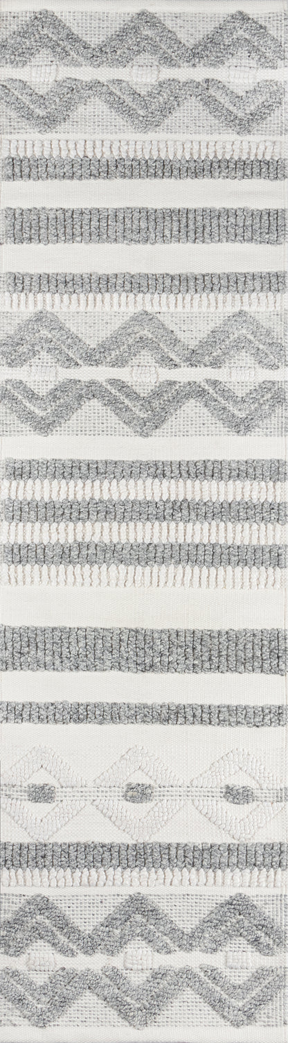 Ivory woven rug with gray boucle zigzag chevrons and horizontal striped bands.