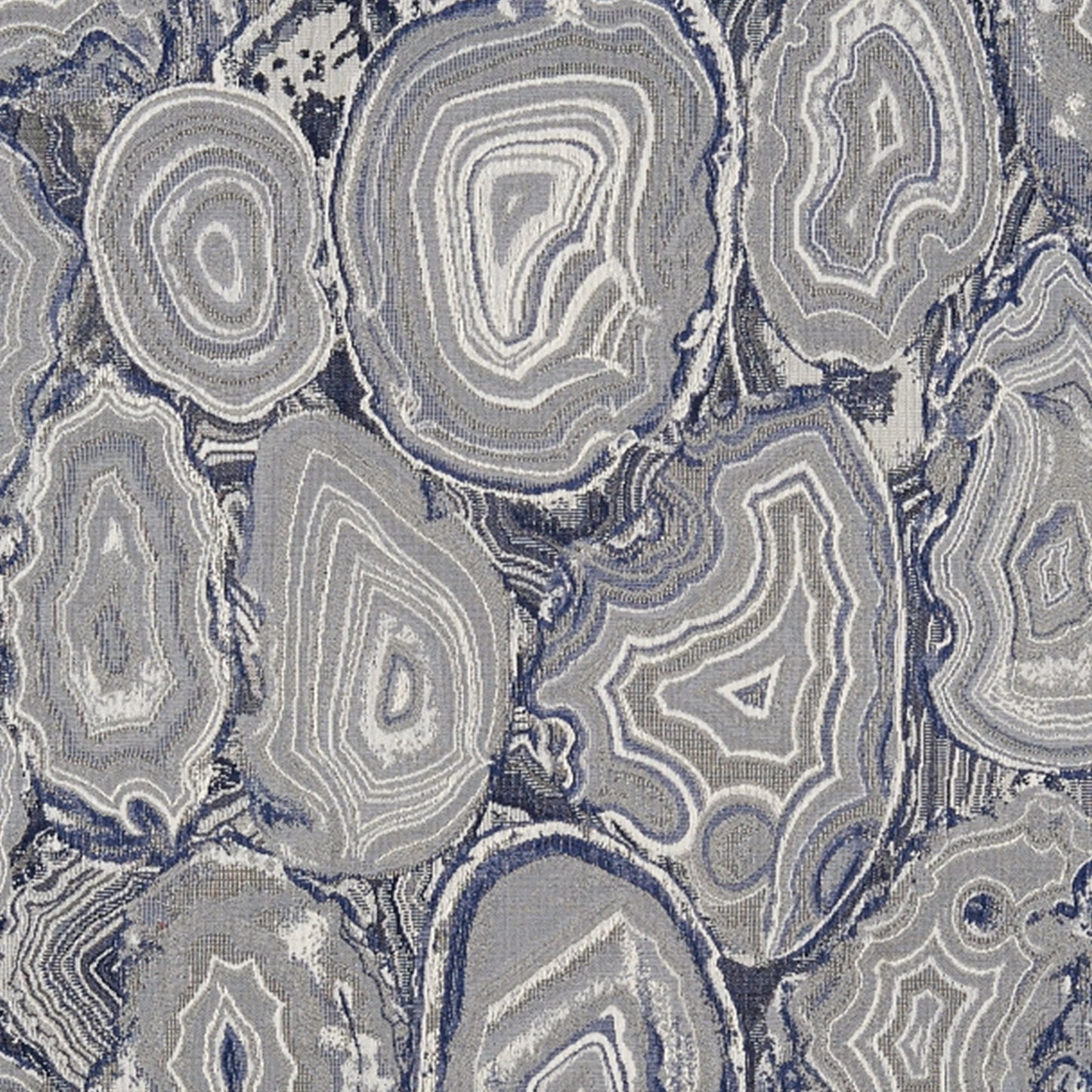 Grey-blue agate/geode pattern with concentric rings and oval shapes; cool-toned textile print for rug or upholstery.