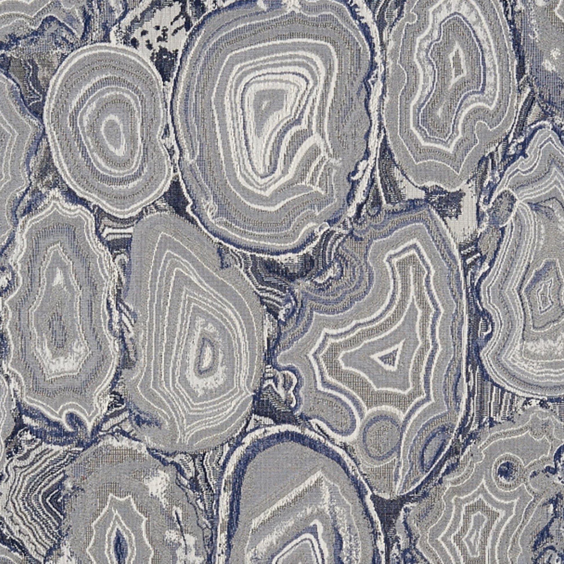 Grey-blue agate/geode pattern with concentric rings and oval shapes; cool-toned textile print for rug or upholstery.