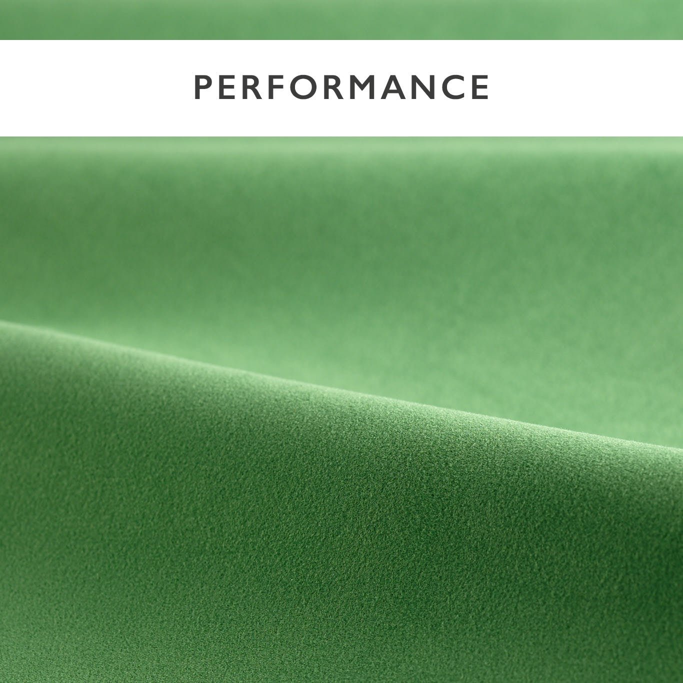Emerald green velvet fabric close-up with a soft fold and smooth finish.