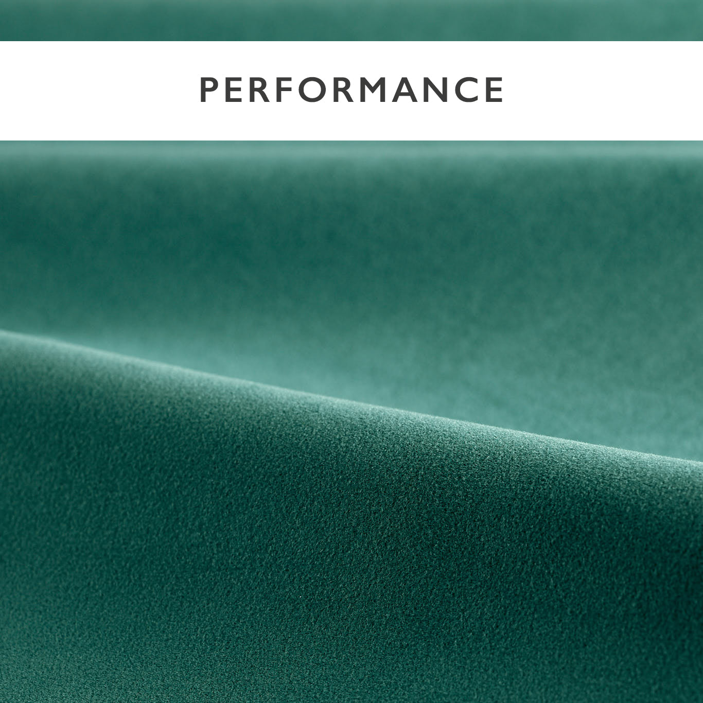 Teal velvet fabric close-up with soft folds, upholstery material.