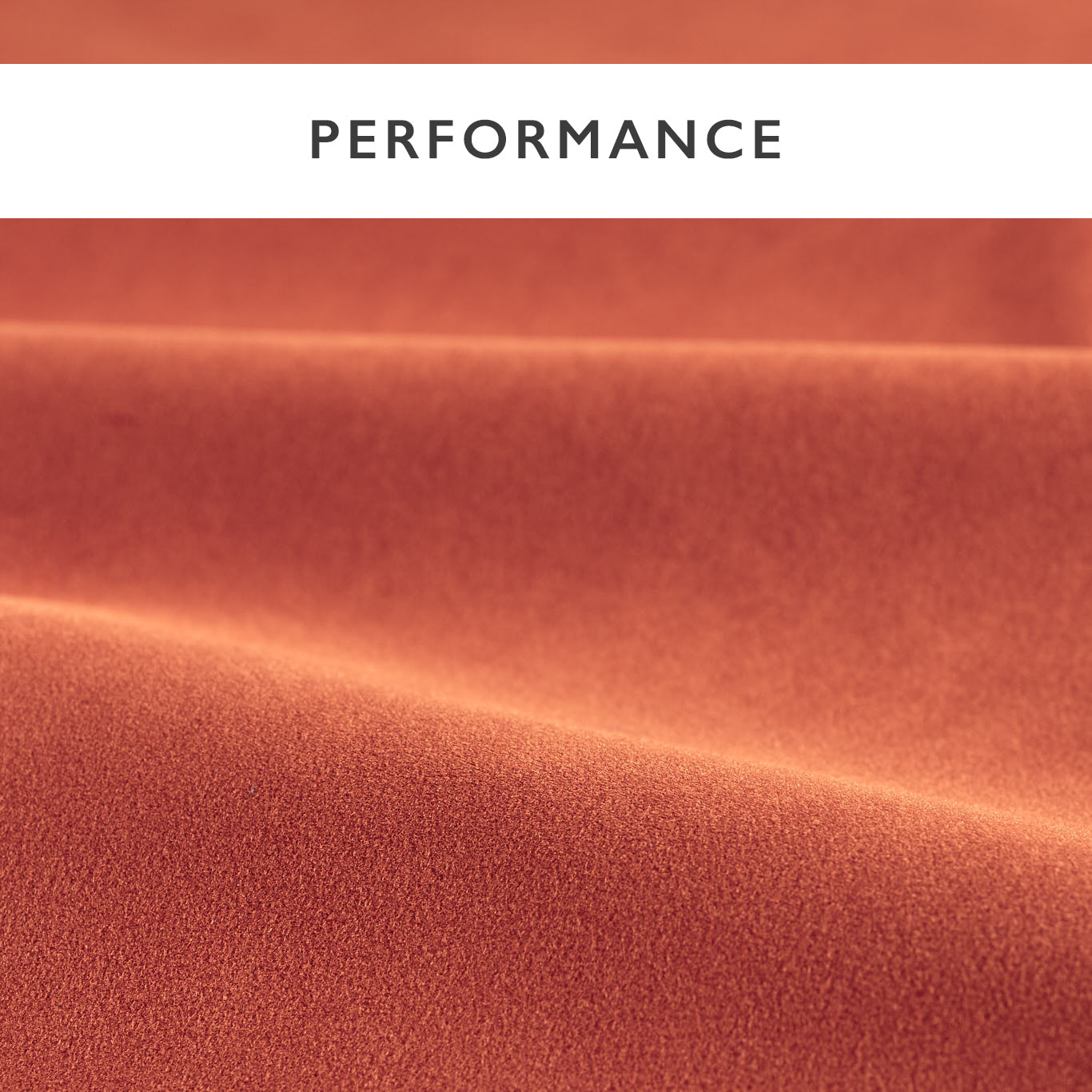 Close-up of rust-colored velvet fabric with soft folds and a textured surface.