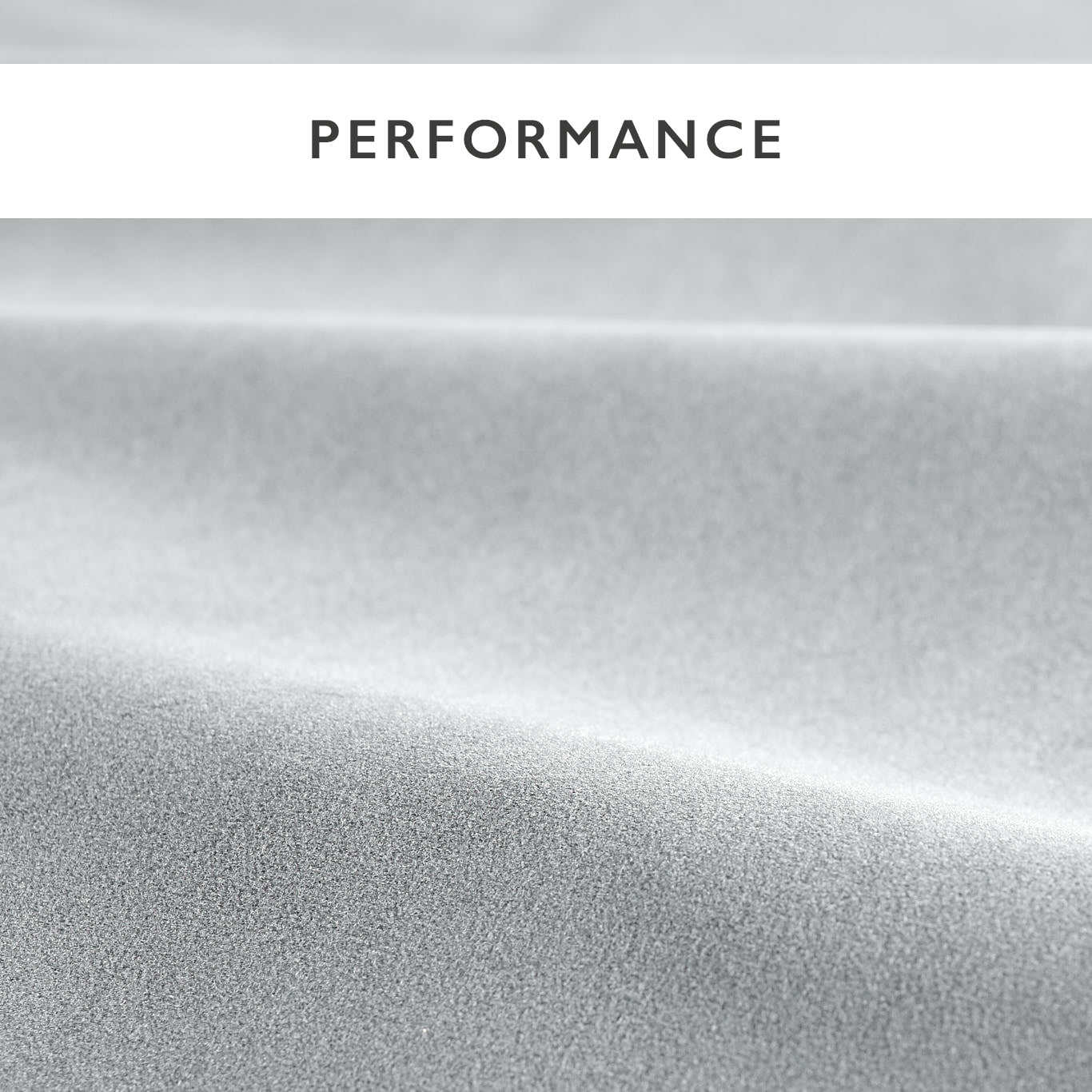 Close-up of light gray textured fabric with fine grain and soft draped folds.
