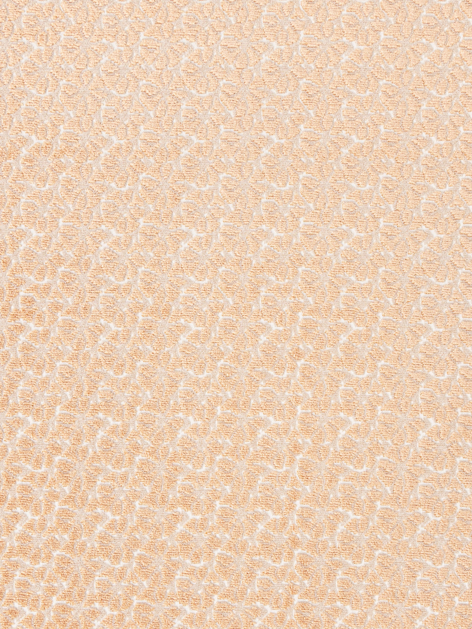 Peach jacquard fabric with delicate white damask motif; soft textured upholstery or drapery textile.