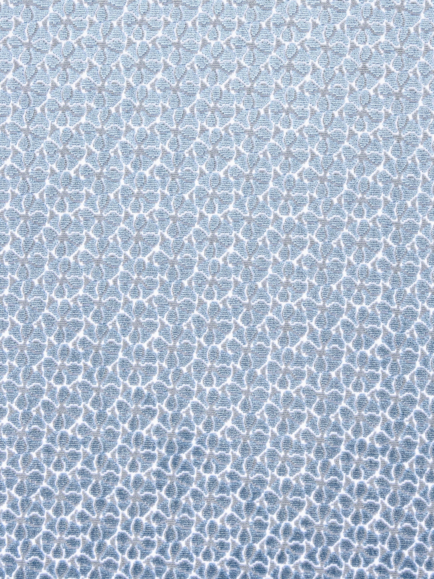 Light blue fabric with a white interlocking lattice motif in a soft textured weave.