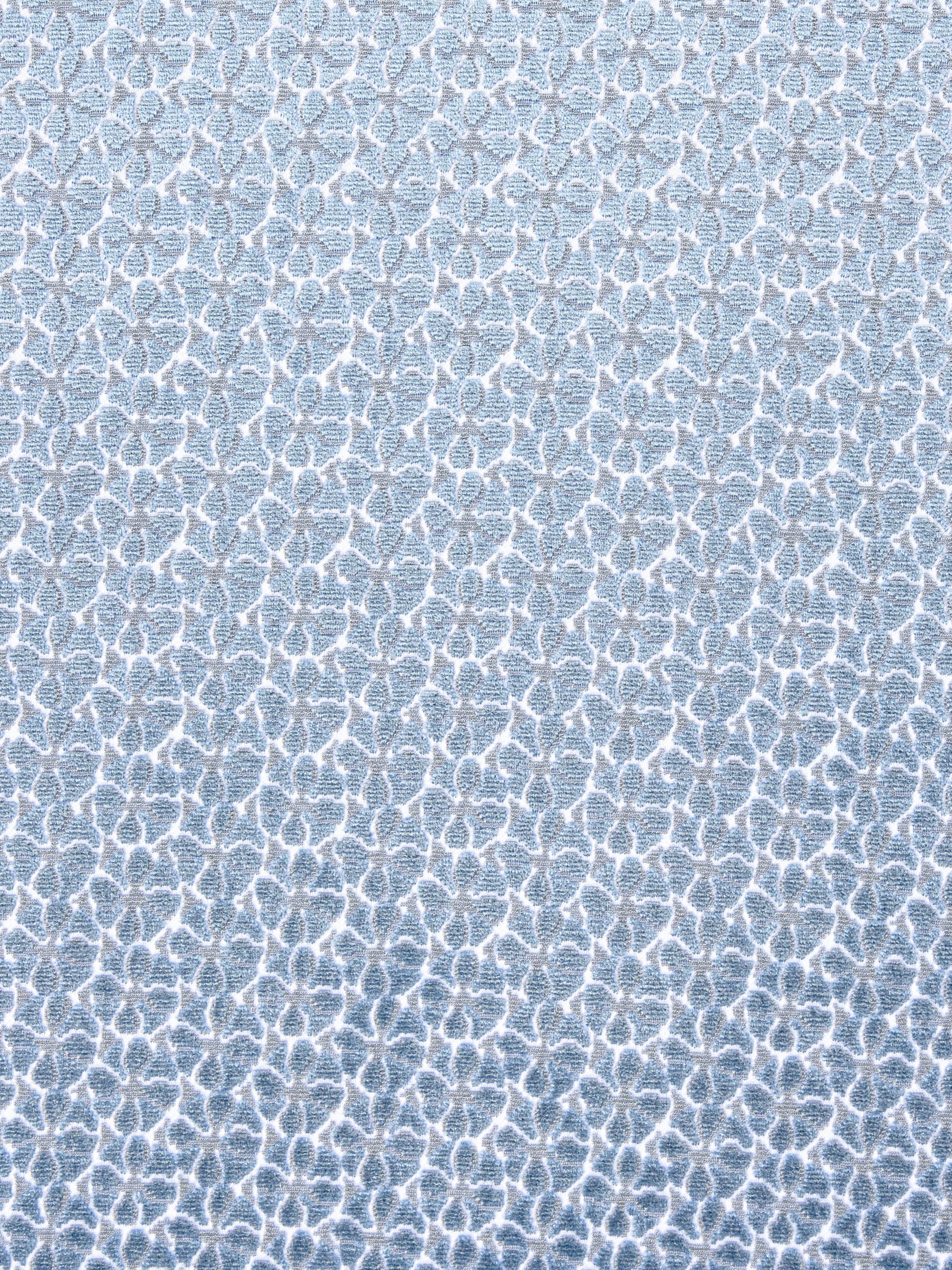 Light blue fabric with a white interlocking lattice motif in a soft textured weave.