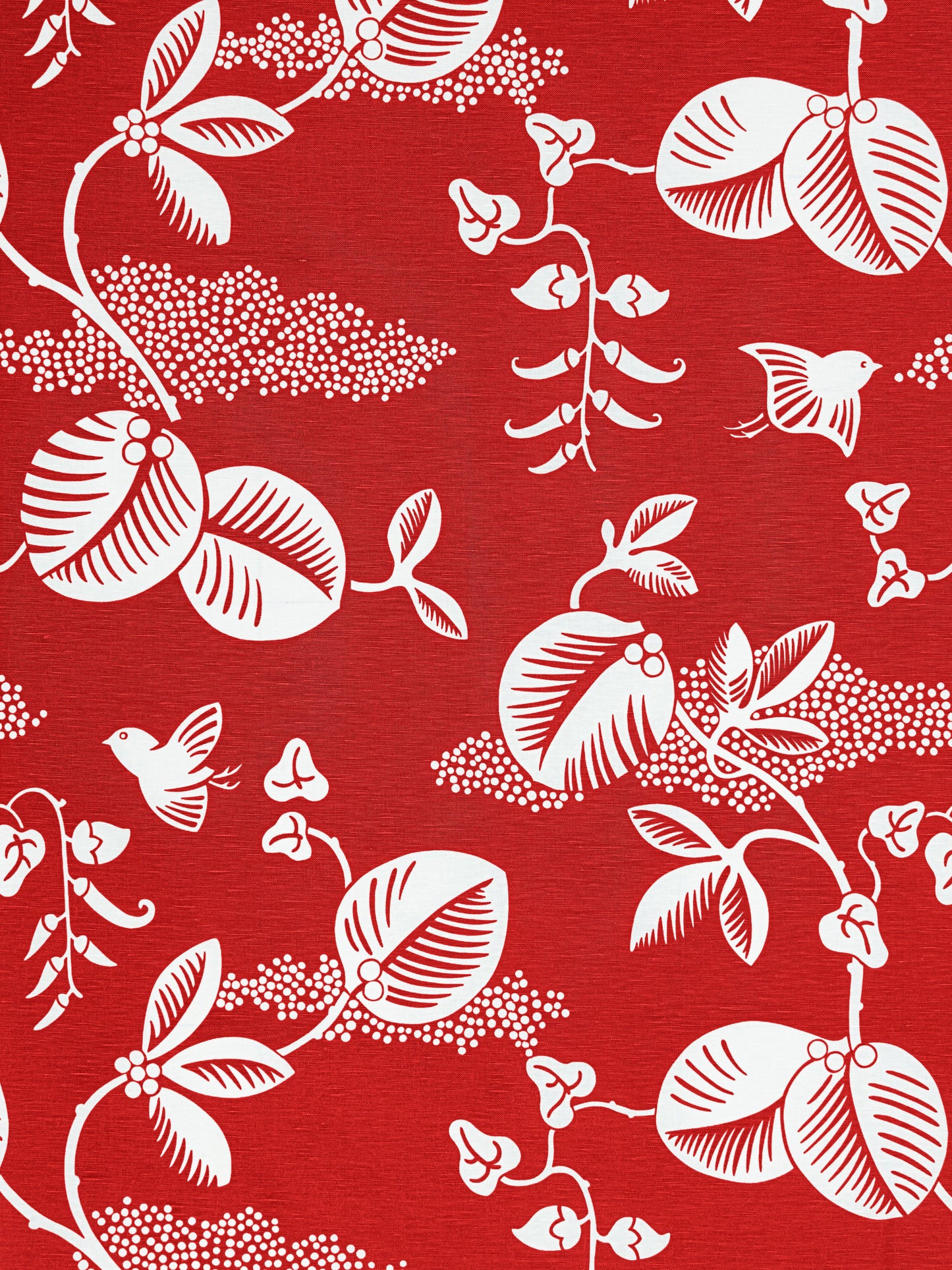 Red fabric with white botanical and bird motif in a classic chinoiserie-inspired pattern.