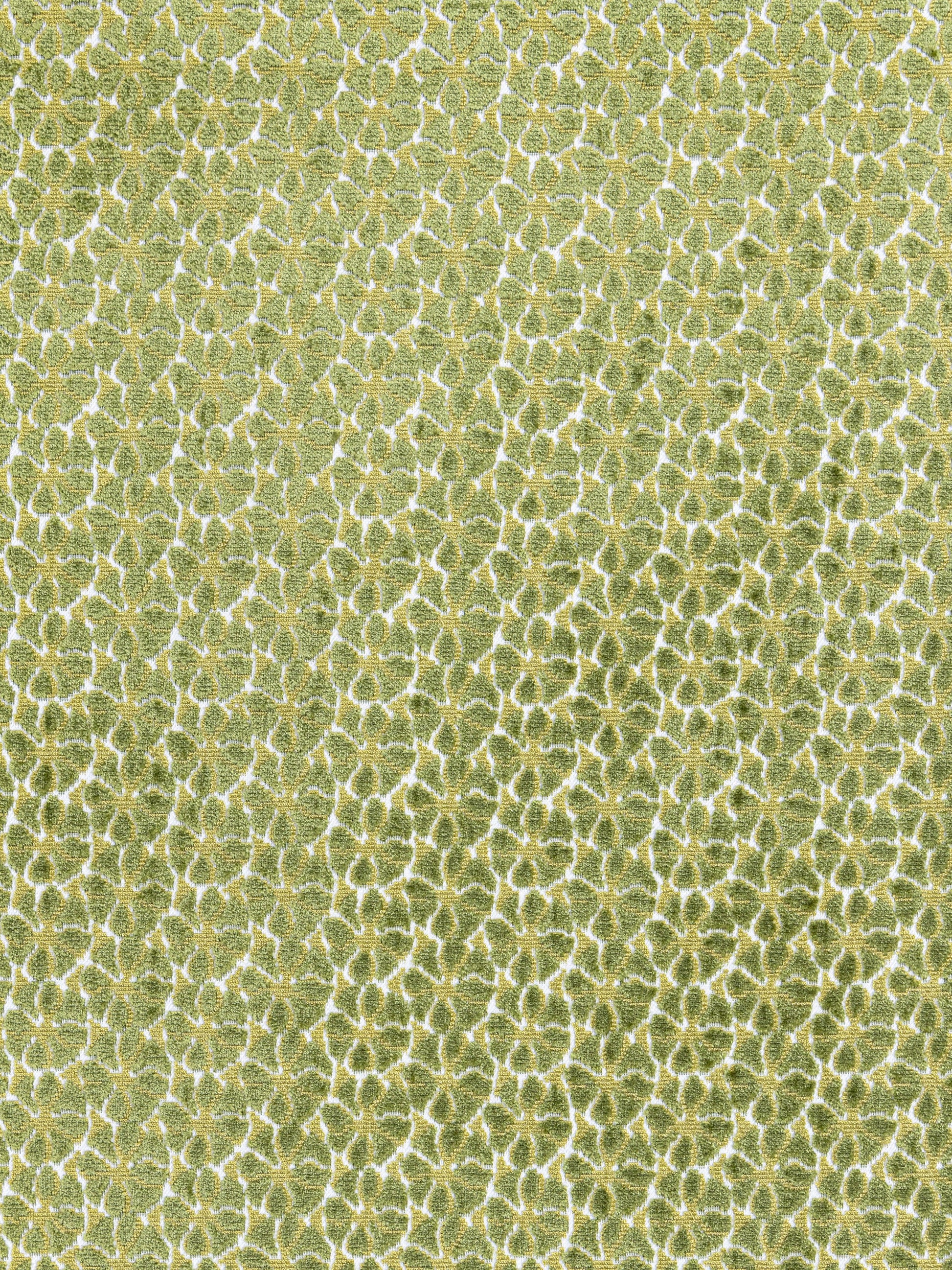 Lime-green textured fabric with a repeating white-edged scale/honeycomb pattern for upholstery or decor.