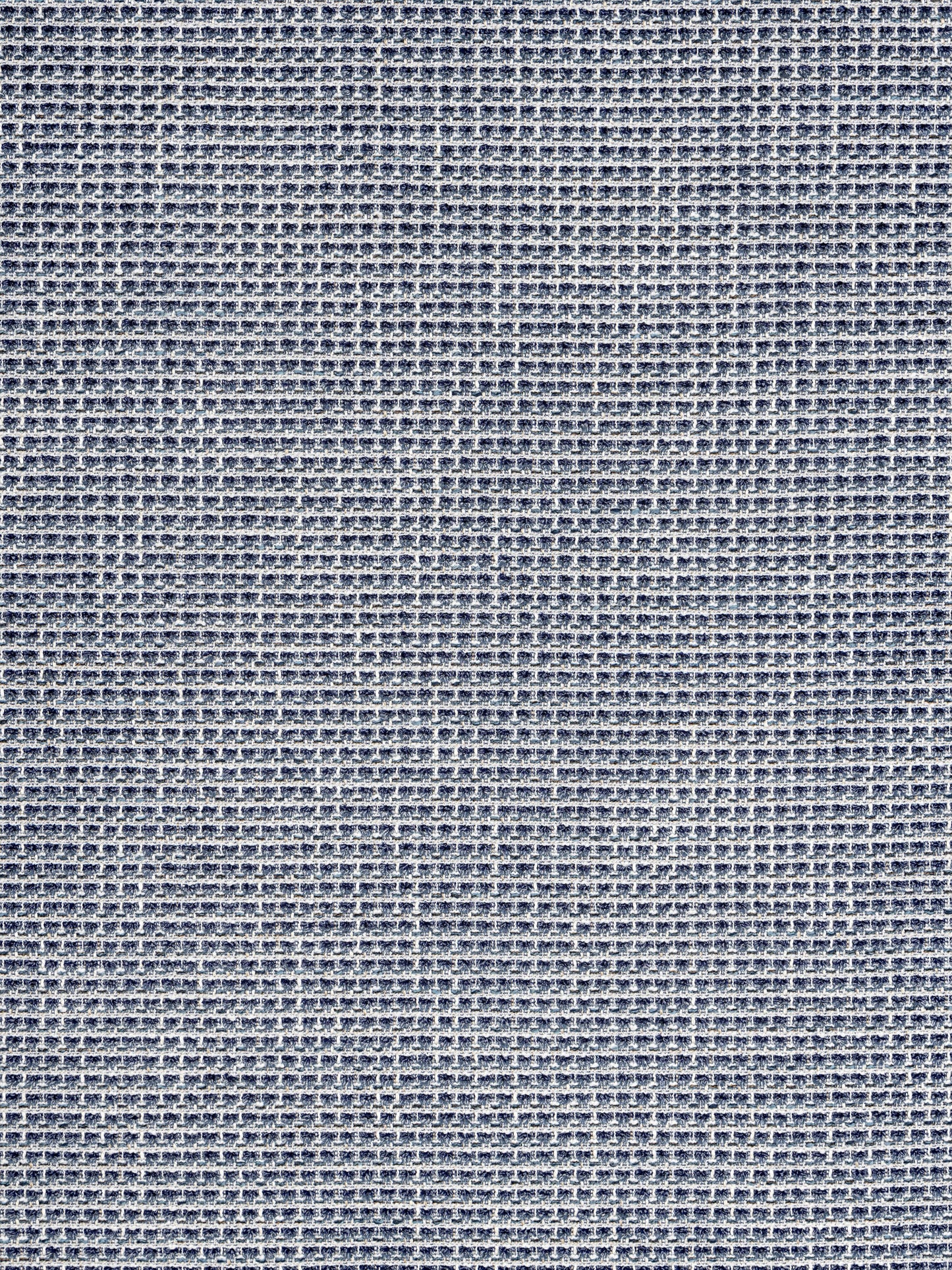 Close-up of blue woven fabric with a tiny grid texture, denim-inspired textile.