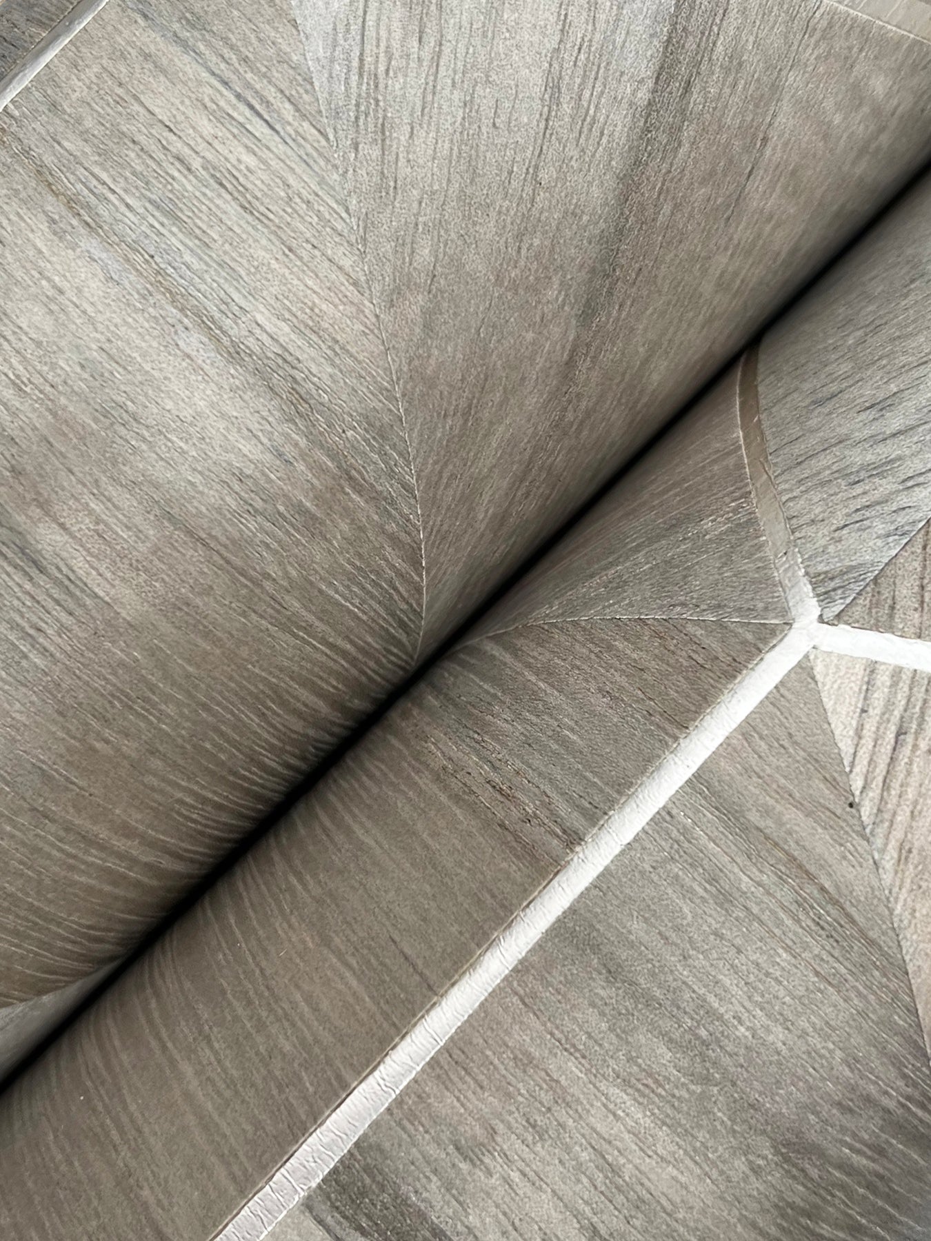 Close-up of brown wood-veneer wallpaper texture.