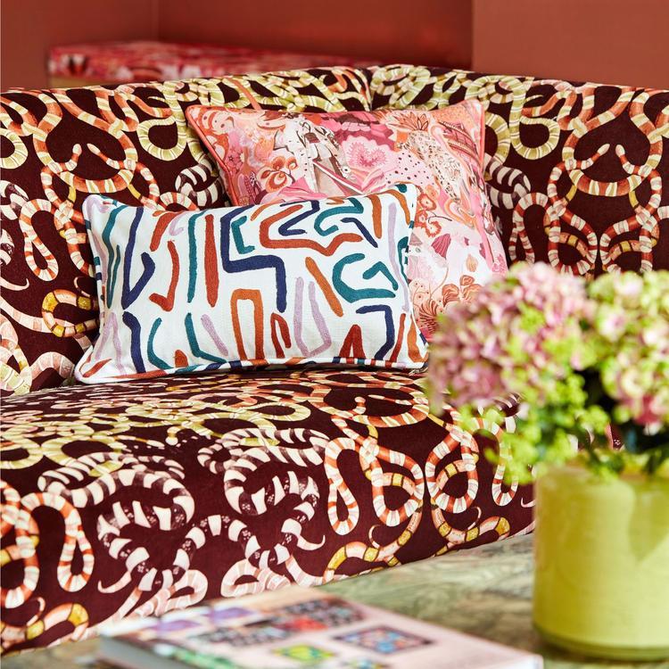 Harlequin Synchronic fabric (HQN2133873) featuring bold abstract graphic motif in Brazilian Rosewood and Onsen Fire tones on a 51% viscose / 27% cotton / 22% linen blend, 54.8″ wide, ideal for upholstery, drapery & feature cushions.