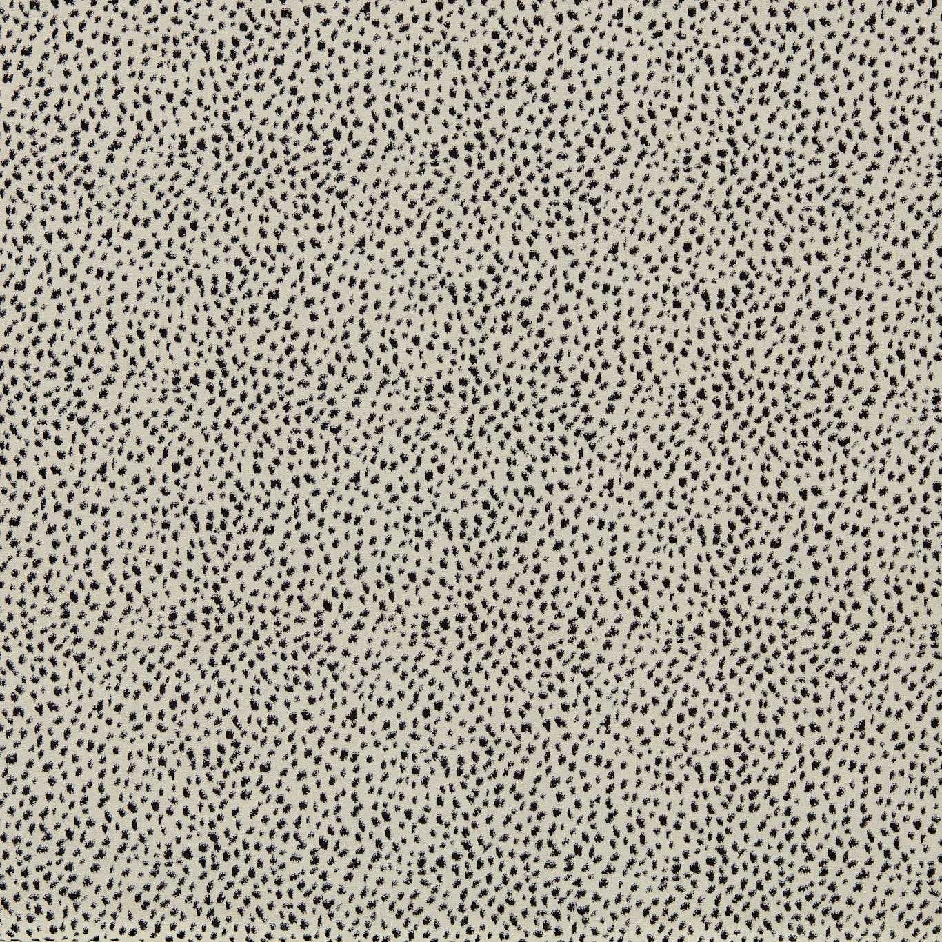 Beige fabric with tiny black Dalmatian-style spots; a spotted print suitable for upholstery or apparel.