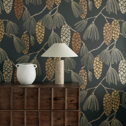 Harlequin Epitome luxury wallpaper in copper, gold, and sepia tones. Stylized pine cones, fir needles, and floral motifs on dark chalk-textured background. Roll width 20.5″ (~1.7 ft), roll length 11 yd (~33 ft), half-drop repeat. Perfect for feature walls and boutique interiors.