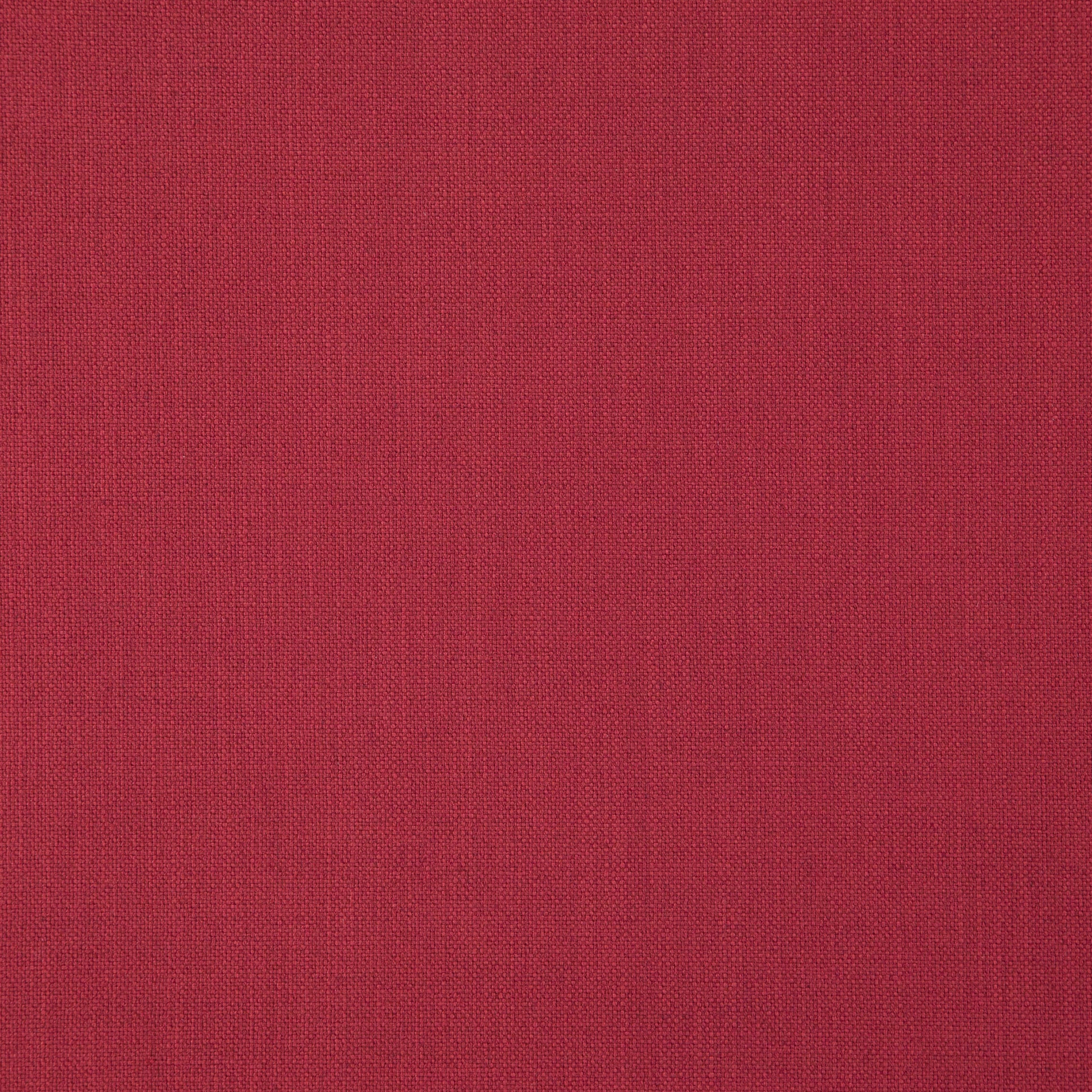 Close-up of red linen fabric texture; deep crimson color with visible fibers, suitable for upholstery or crafts.