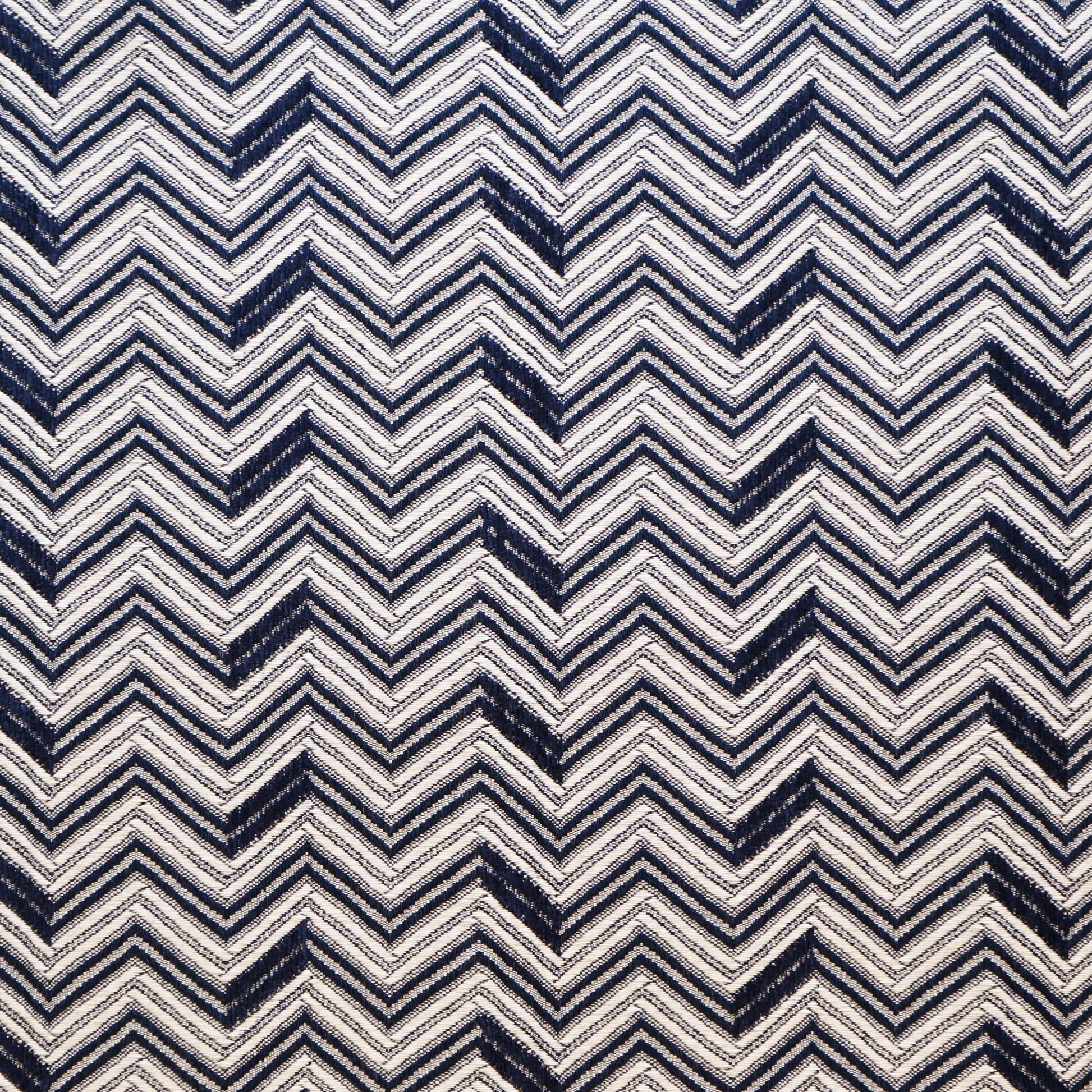 Navy and ivory chevron zigzag jacquard fabric pattern; bold geometric textile.