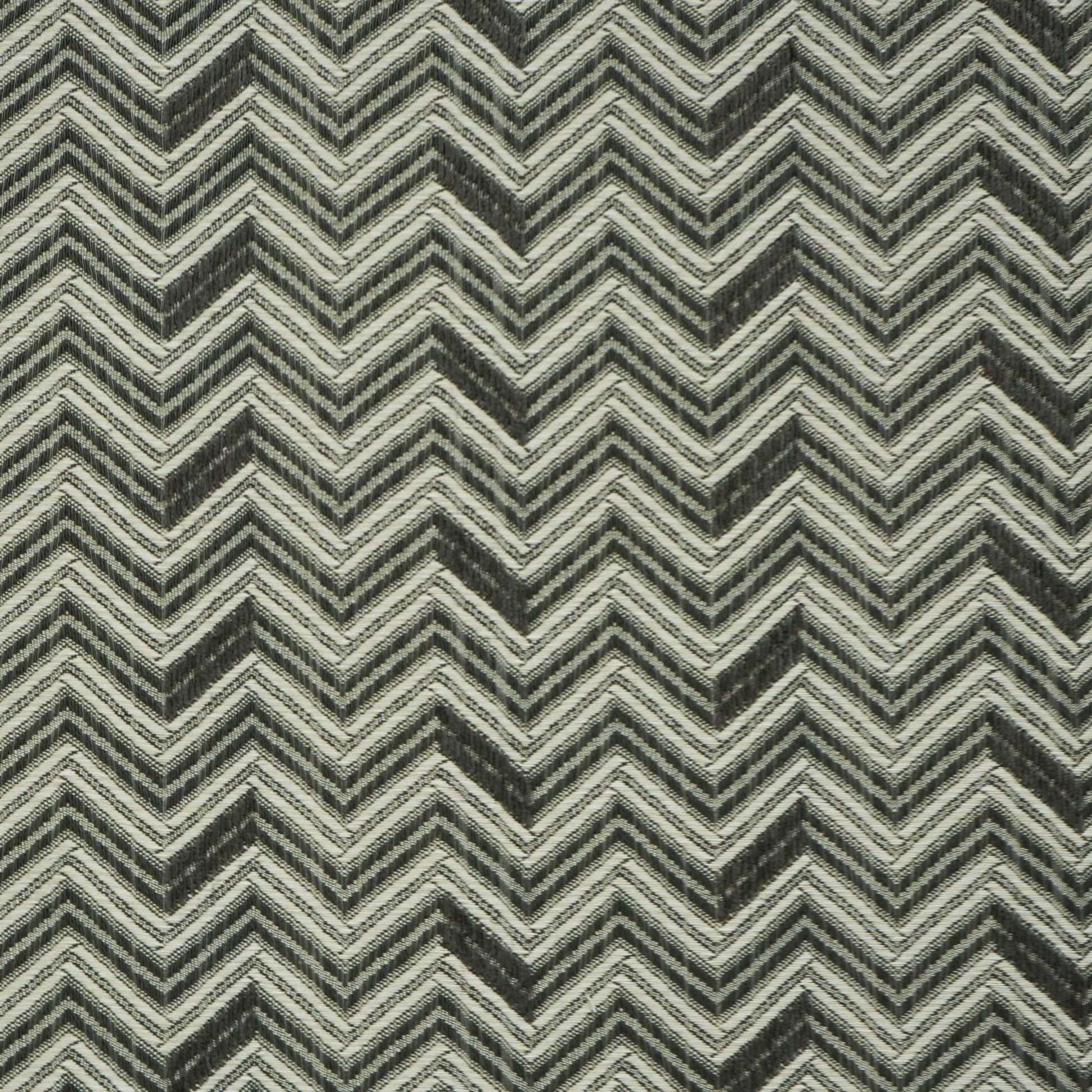 Gray and black chevron-patterned jacquard fabric with off-white accents; bold zigzag woven design.