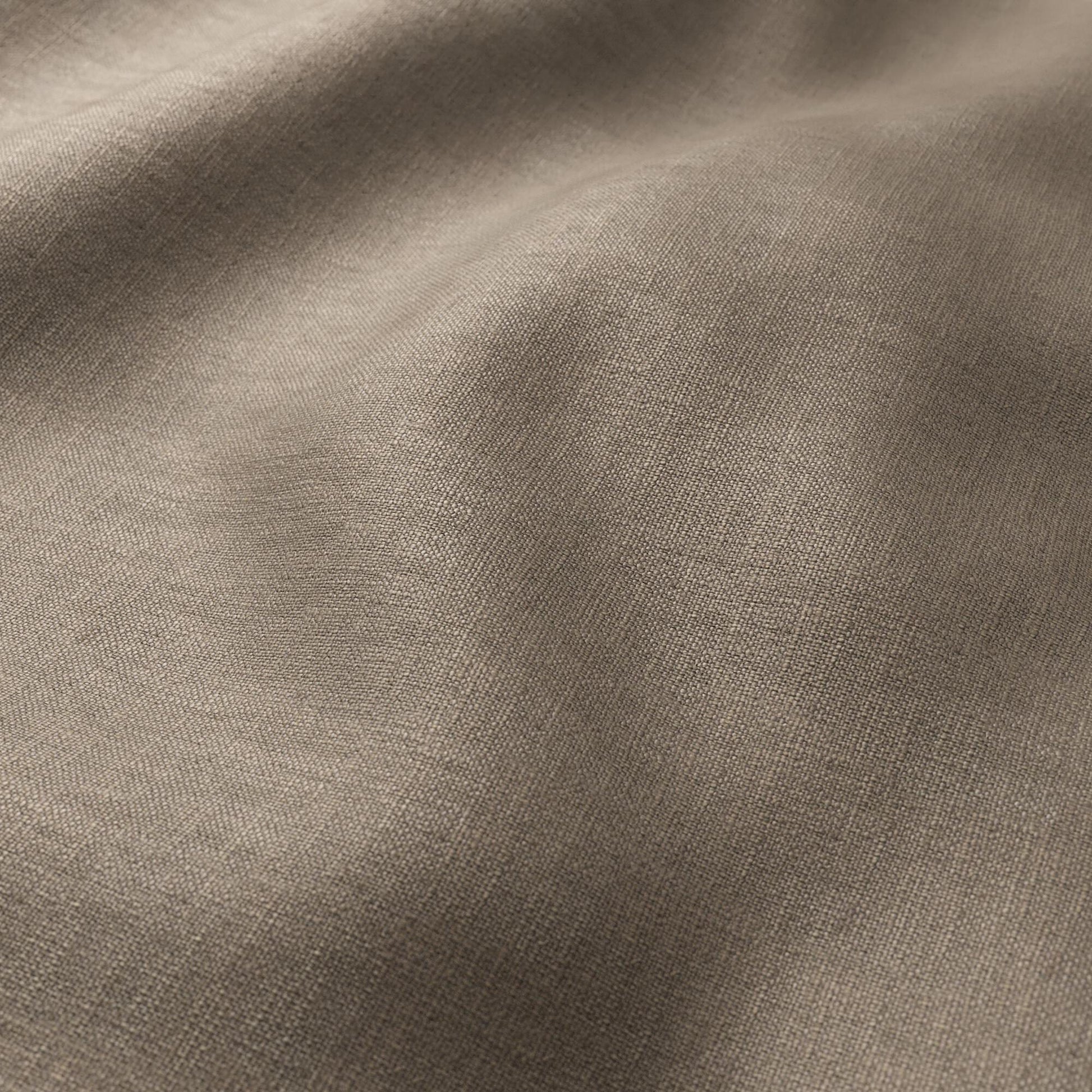 Brown chocolate linen-textured fabric close-up with soft drape and fine weave; plain, woven textile for clothing or home décor.