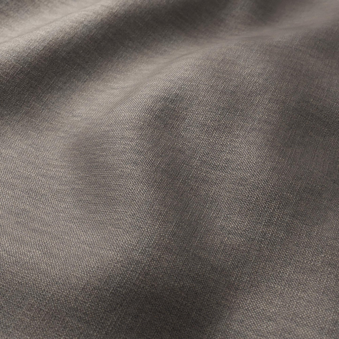 Textured chocolate-brown woven fabric with gentle folds; linen texture, plain weave; versatile for clothing or home decor.