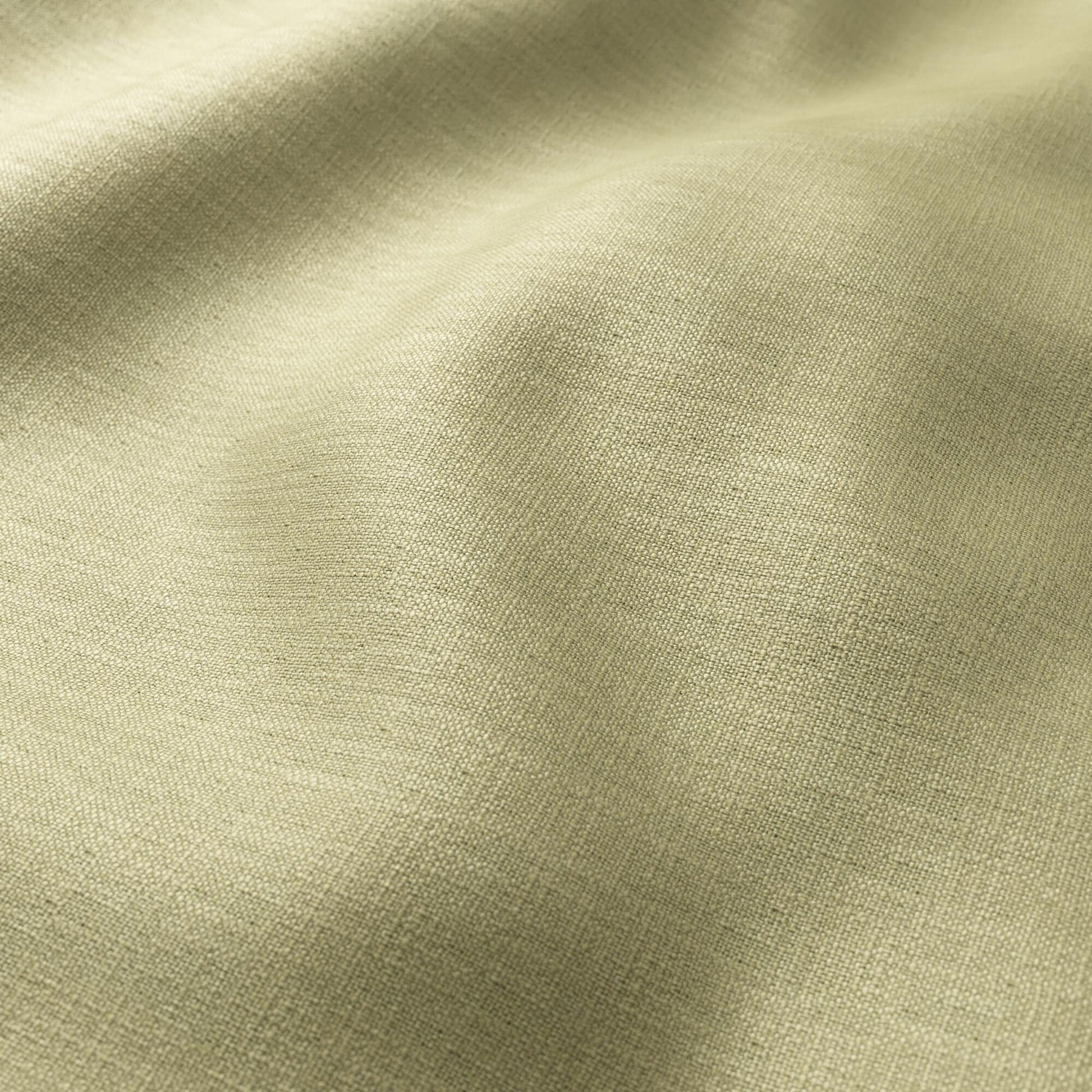 Green khaki linen-texture fabric close-up with visible weave and soft, flowing folds.