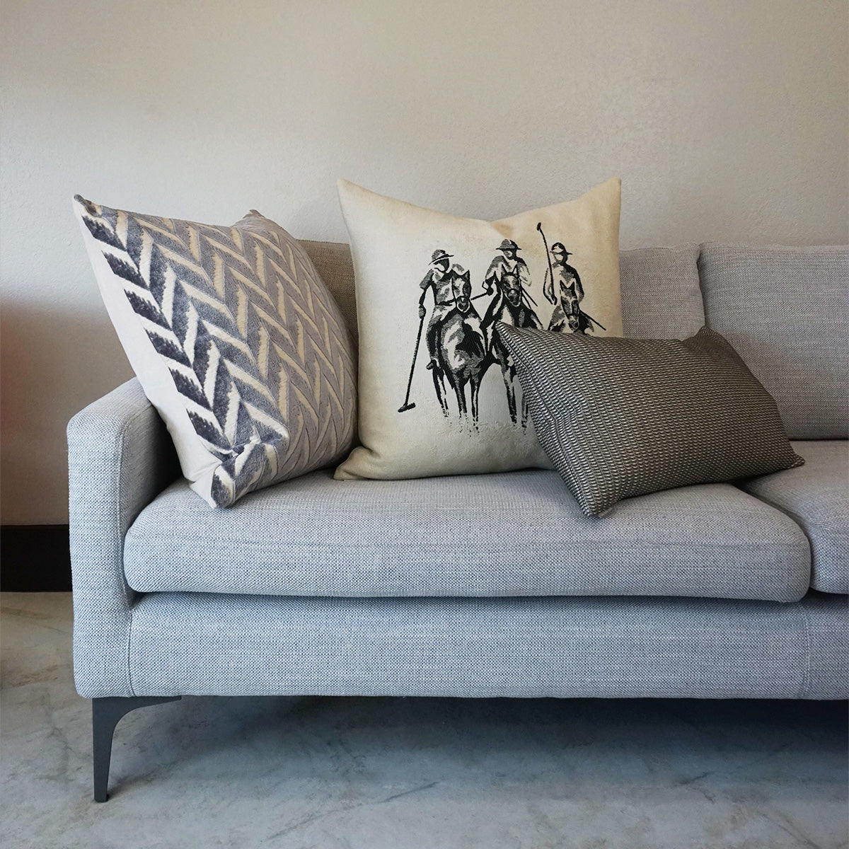 Light gray novelty pillow with polo-players print.