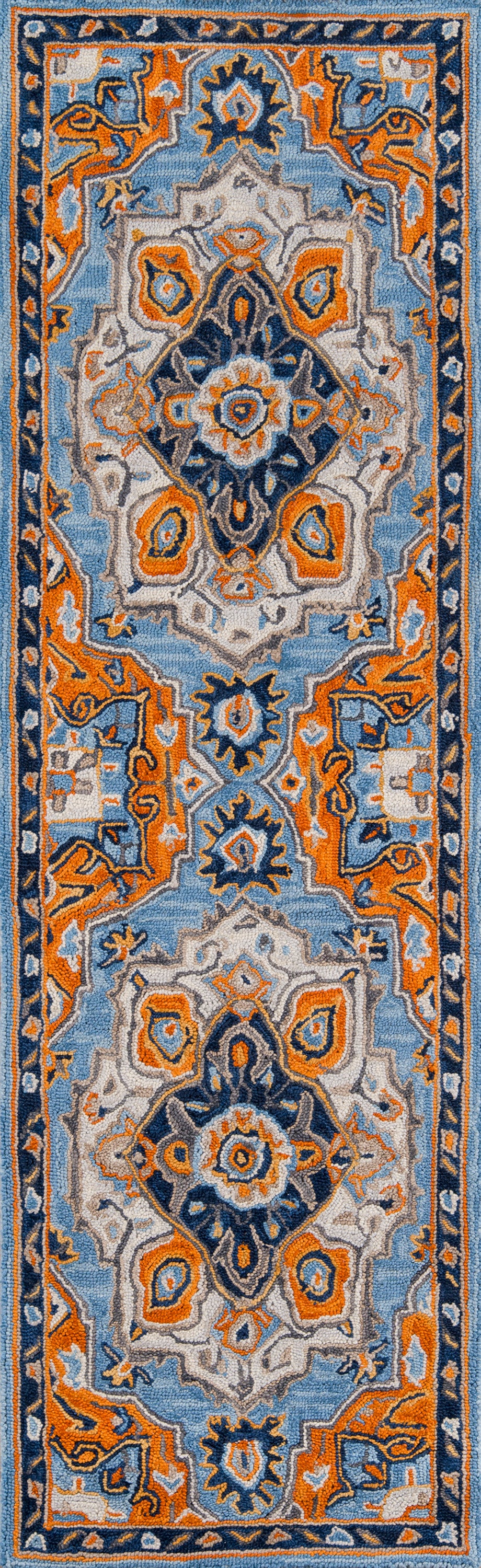 Persian-style rug with light blue field, orange accents, ivory center medallions, and navy border; 2' x 3'.