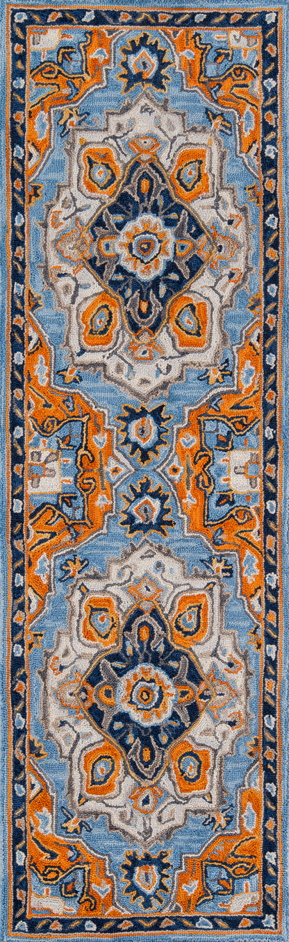 Persian-style rug with light blue field, orange accents, ivory center medallions, and navy border; 2' x 3'.