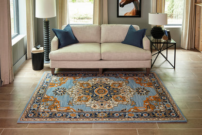 Blue and orange oriental rug with beige and navy accents; 2' x 3' size in a modern living room with wood floors.