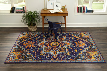 Oriental rug with navy base and orange and gold geometric medallion, rectangular, in a home office.