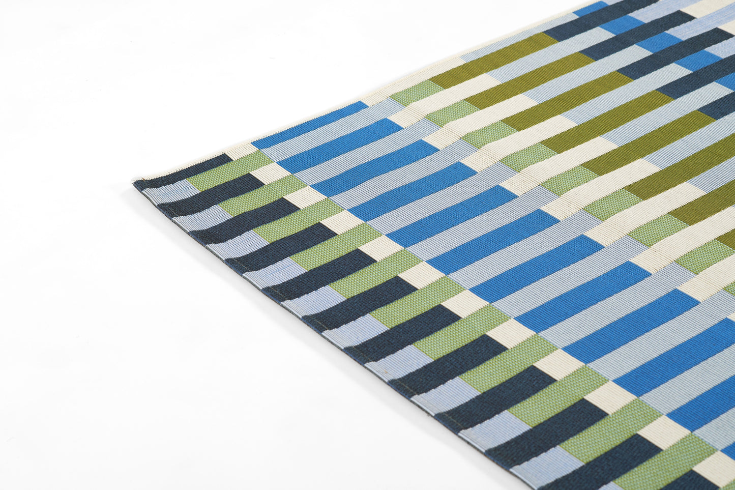 Woven rectangular rug in blue, olive green, cream & gray blocks forming a geometric striped checker pattern; modern rug.