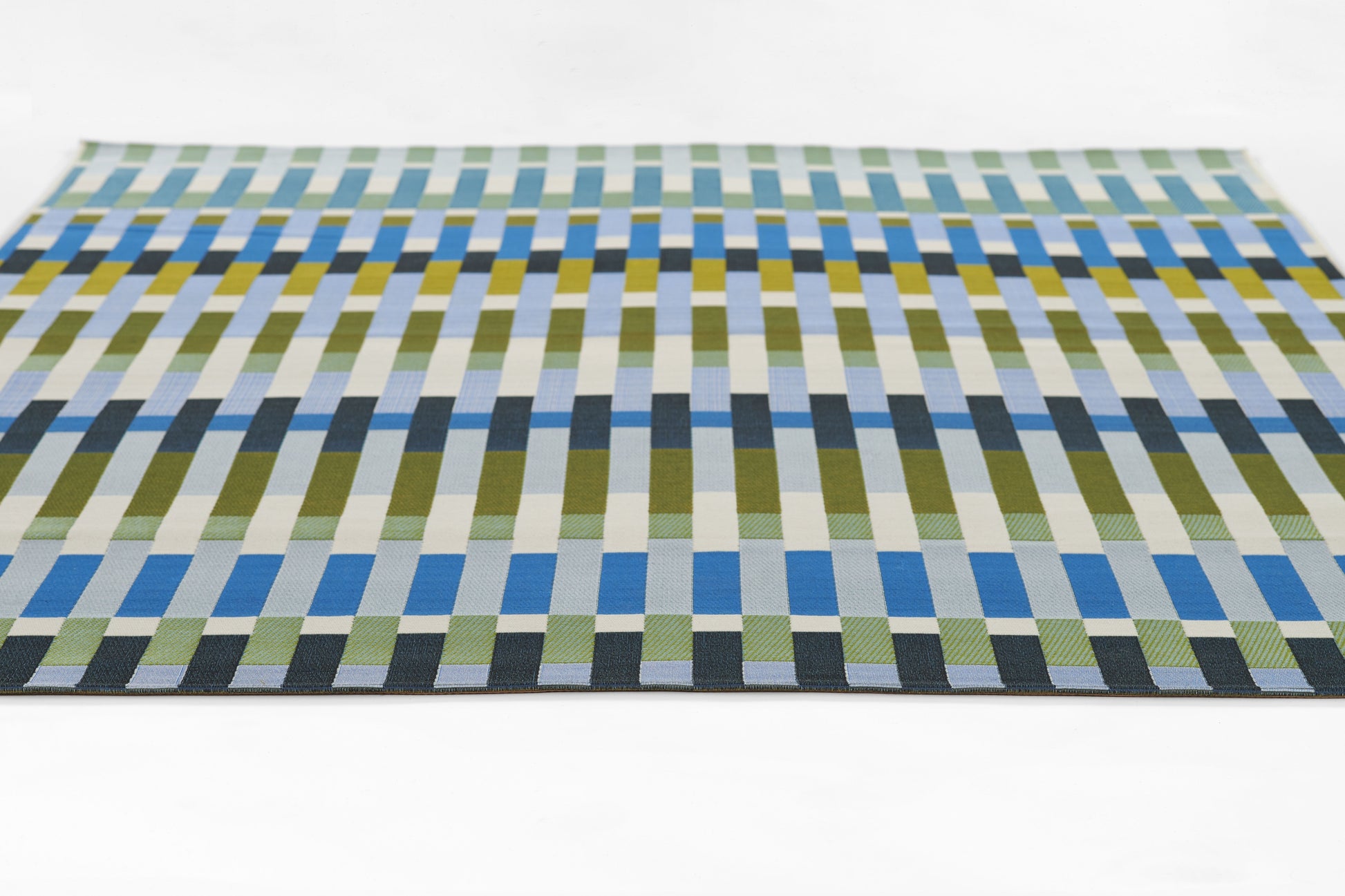 Rectangular woven rug with a modern geometric grid of blue, green and yellow stripes.
