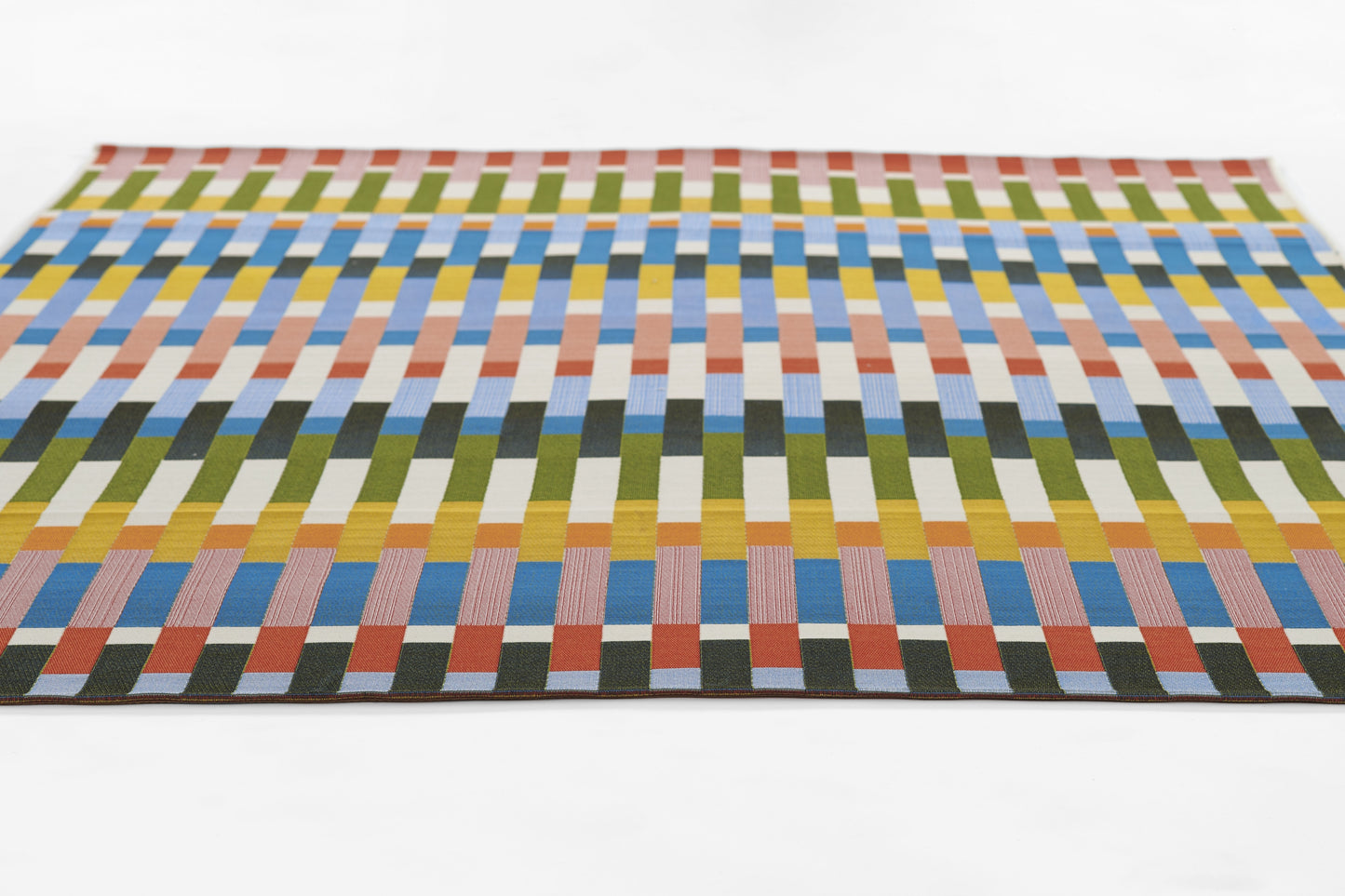 Rectangular woven rug with multicolor vertical blocks in greens, blues, yellows, oranges; modern geometric design.