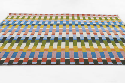 Rectangular woven rug with multicolor vertical blocks in greens, blues, yellows, oranges; modern geometric design.