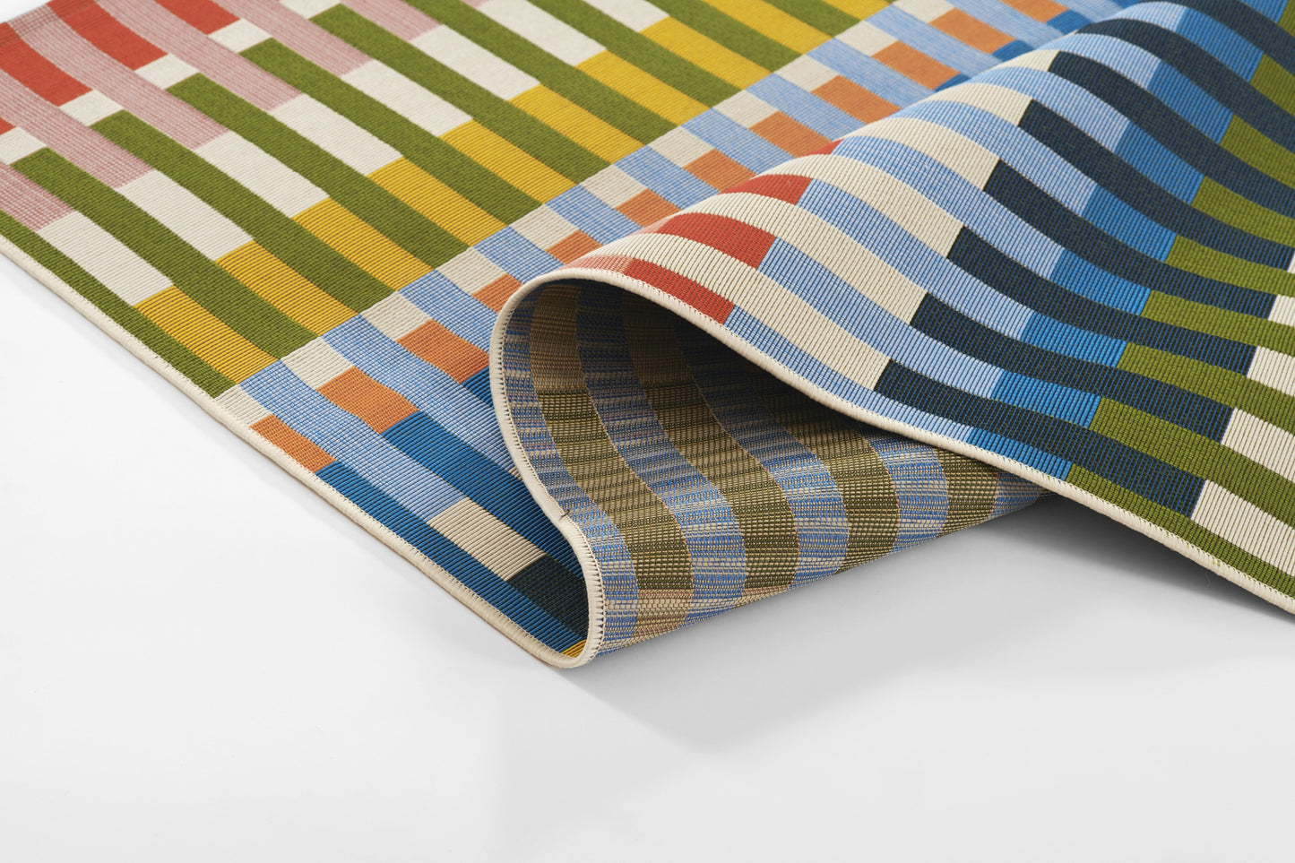 Multicolor striped woven rug with red, green, yellow & blue bands; rolled corner.