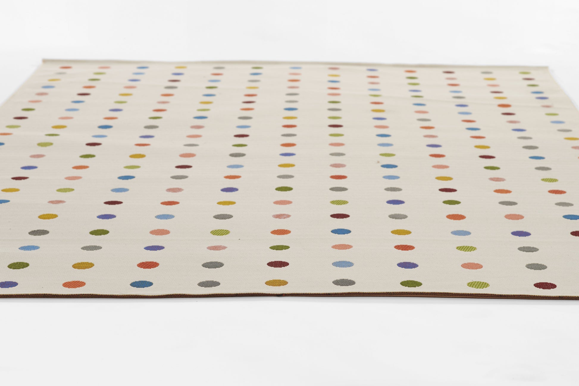 Beige rectangular area rug with evenly spaced multicolor dots arranged in vertical columns across the surface.