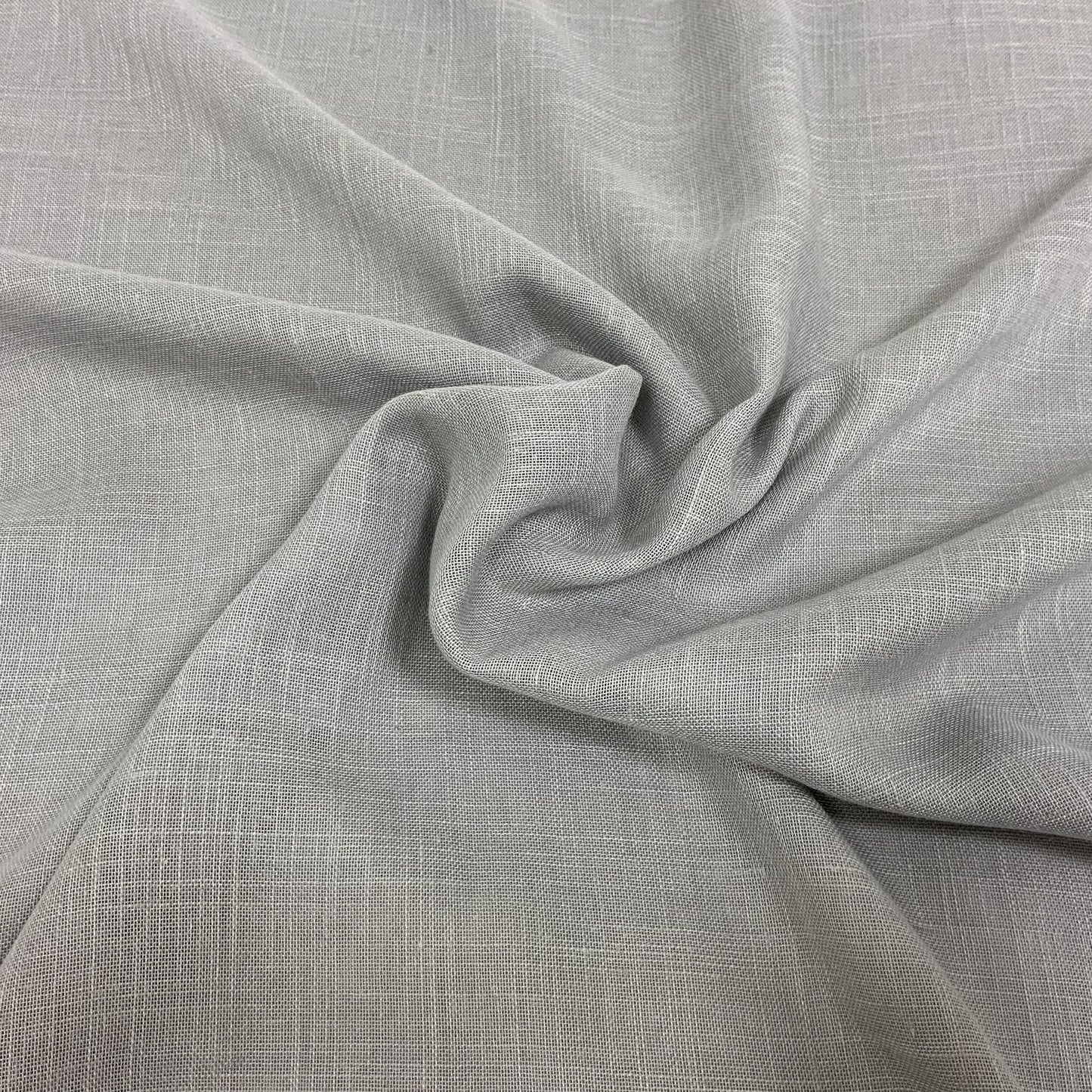 Light gray linen-like fabric with subtle woven texture and soft drape; versatile for apparel or home decor.