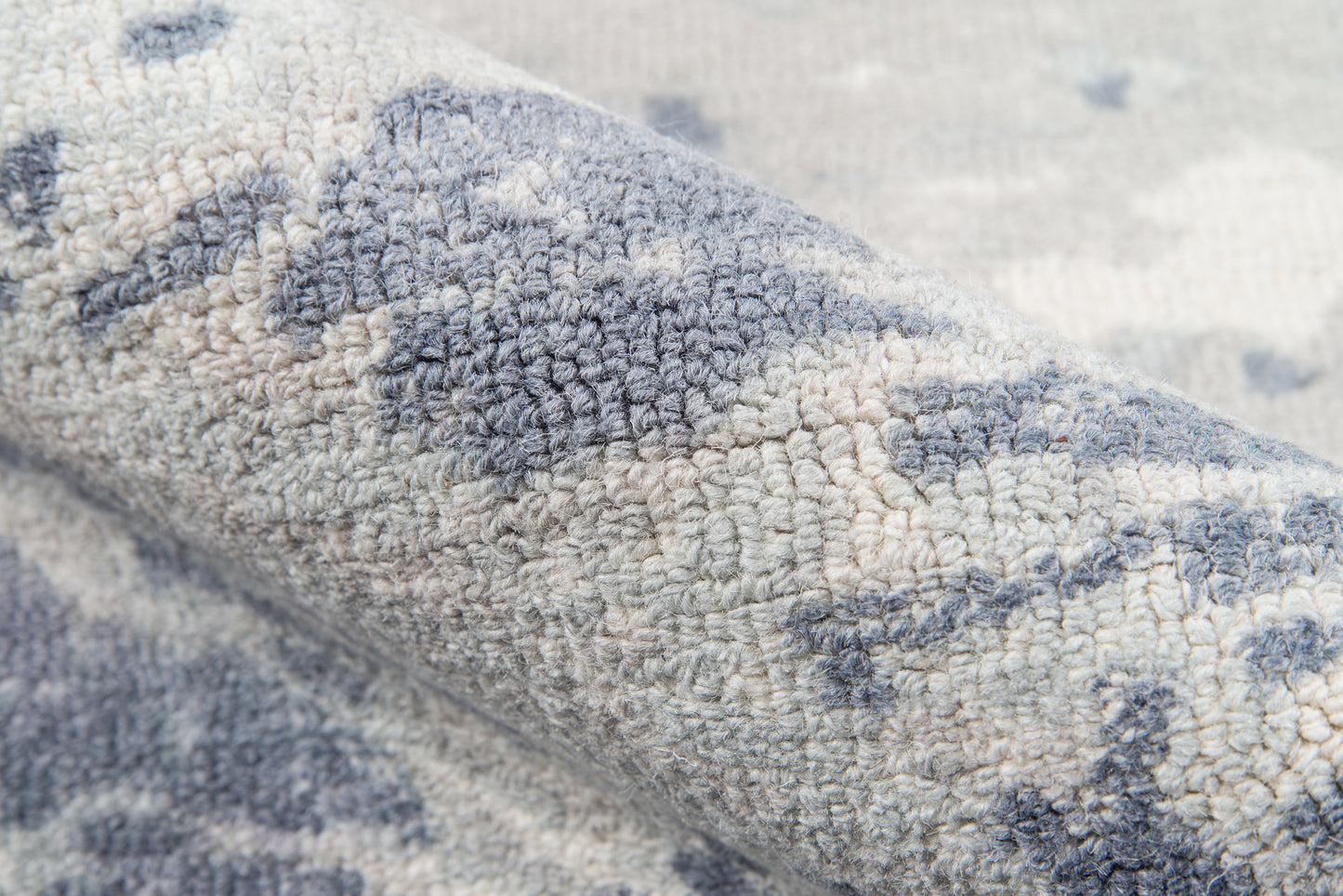 Blue and ivory patterned plush fabric with soft looped pile and abstract motif.