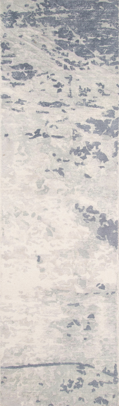 Blue-gray irregular blotches on pale background; modern abstract textile or wallpaper print.