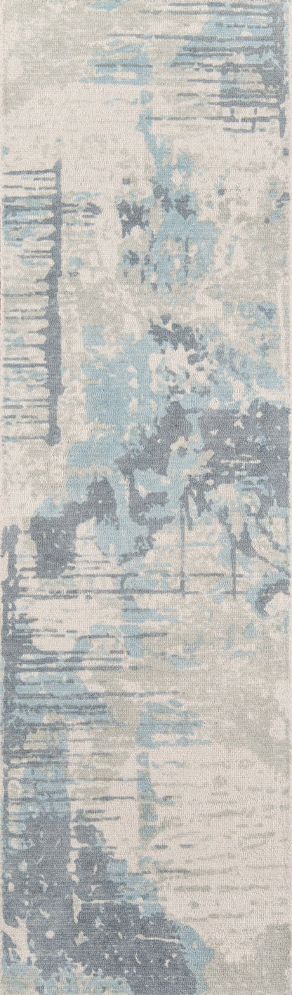 Rectangular abstract area rug in pale blue, ivory and gray with watercolor-style pattern and soft textured pile.