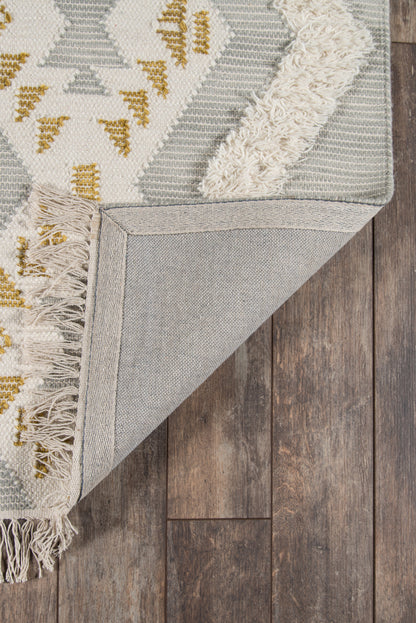 Grey and ivory geometric runner with gold accents, fringed edges, woven texture, turned corner showing underside on wood floor, 2' x 8'.