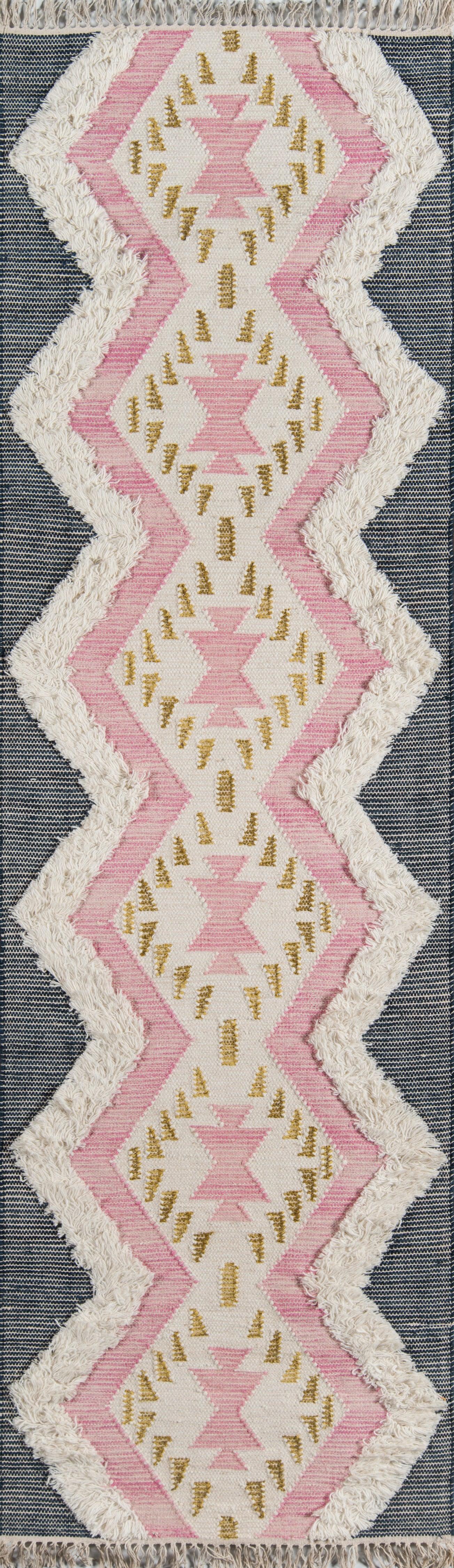 Pink and cream geometric area rug with zigzag diamonds, gold accents and white fringe.