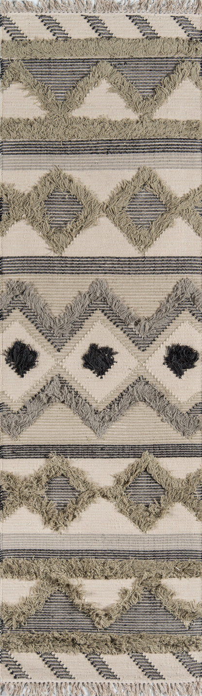 Boho woven runner rug in cream and beige with shaggy fringe, navy chevron diamonds and striped bands.