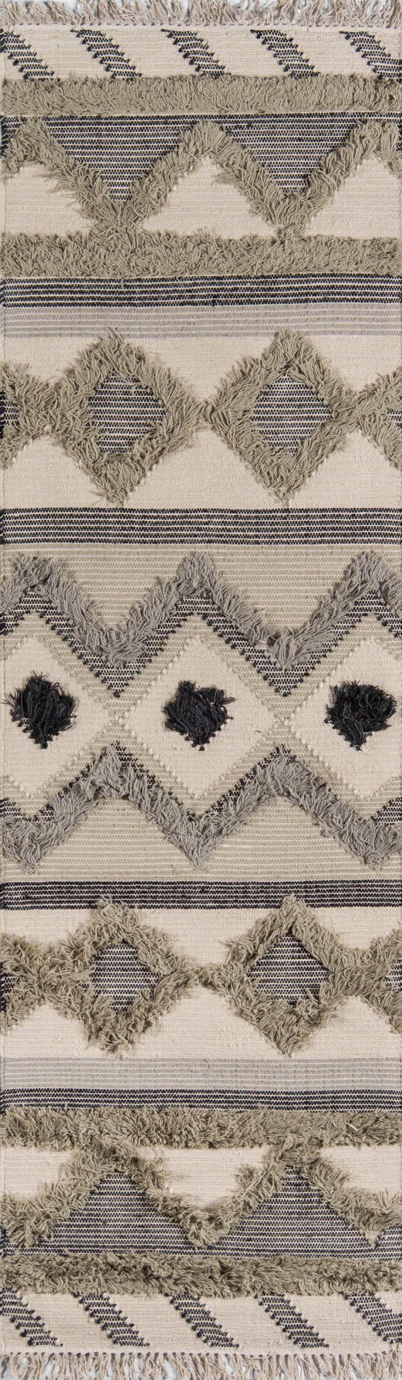 Beige boho rug with sage diamond zigzags, navy stripes and fluffy fringe along edges.