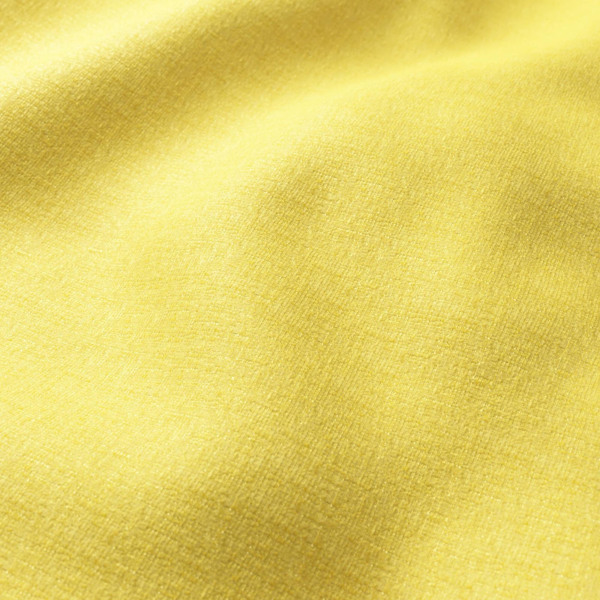 Bright yellow chenille fabric close-up with plush texture and gentle folds.