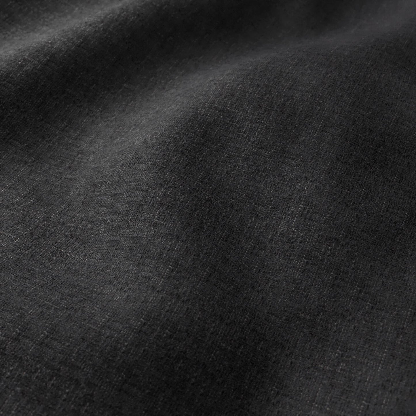 Charcoal black woven fabric with subtle texture and soft drape, ideal for garments.